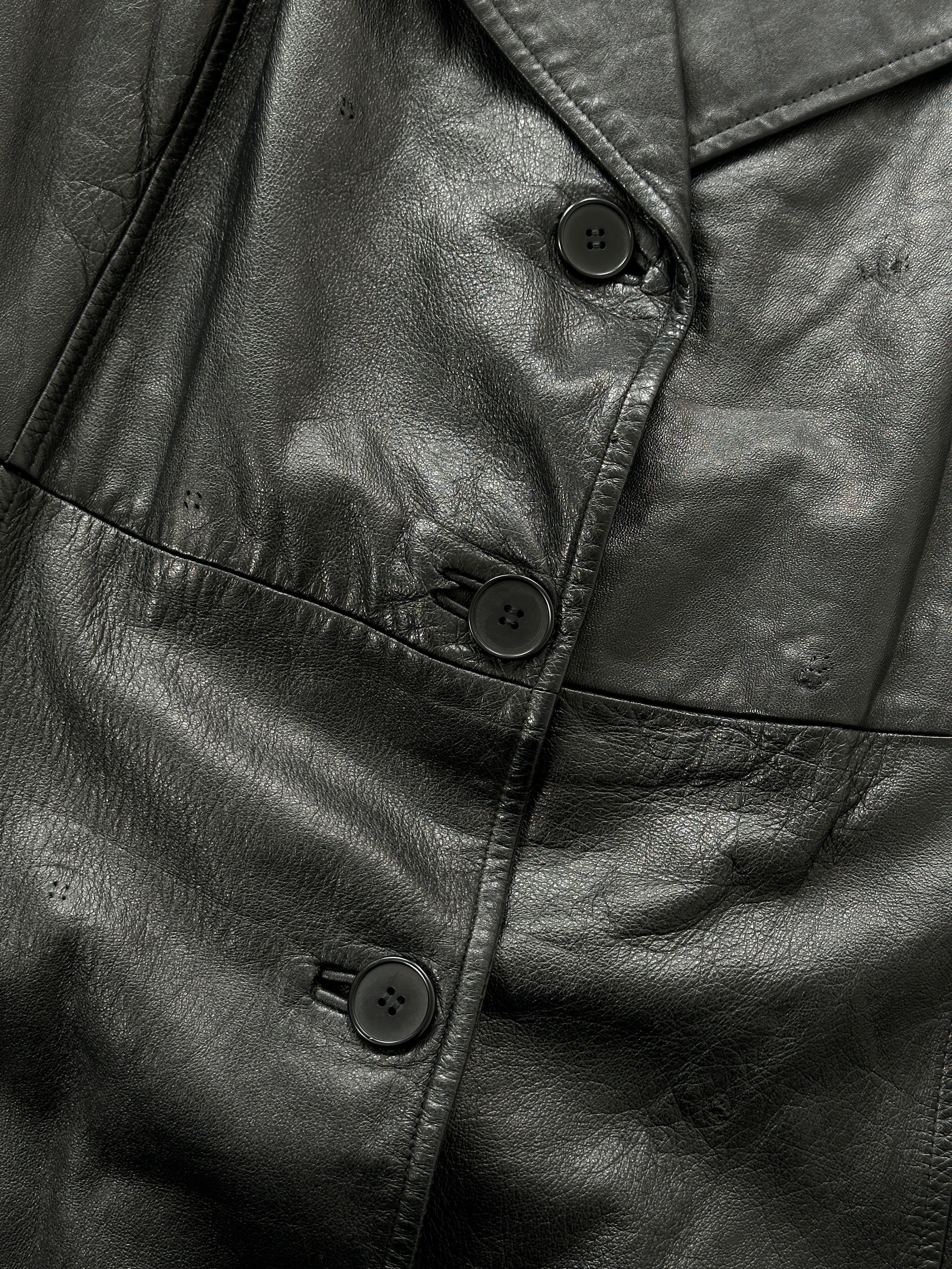 Vintage leather trench coat with belted waist, classic design, long sleeves, and a tailored fit in a timeless vintage style.
