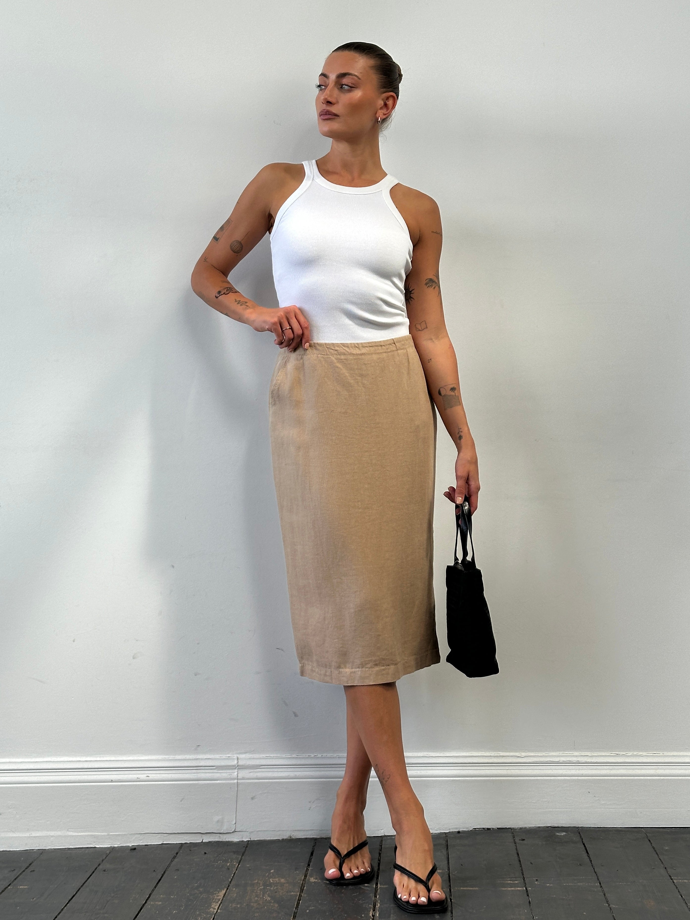 Max Mara pure linen midi skirt in W28, shown in a light, flowing fabric with a sleek, elegant silhouette.