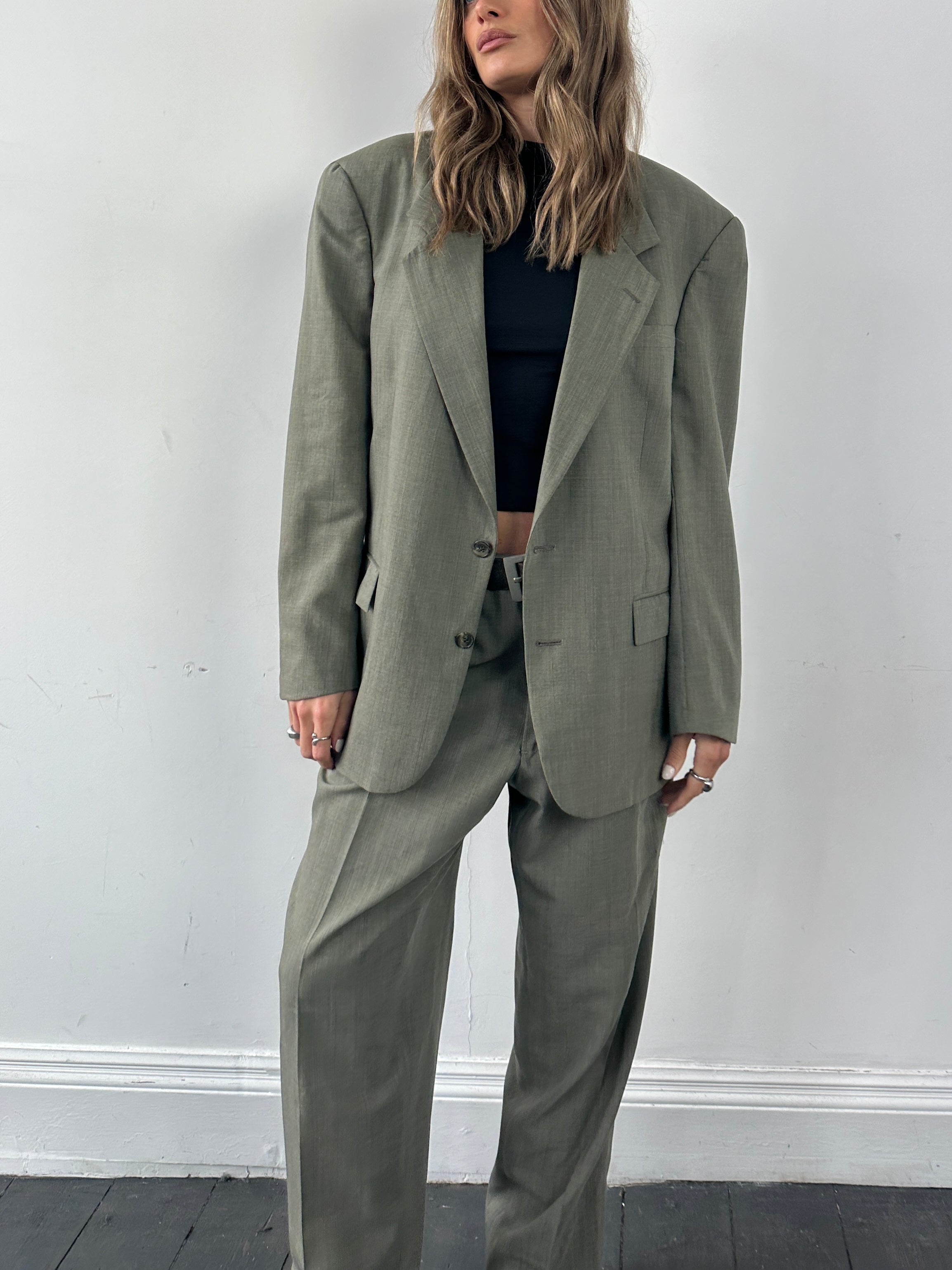 Christian Dior virgin wool jumpsuit, single-breasted design in size 42R/W32, tailored fit with lapel collar and front pockets.
