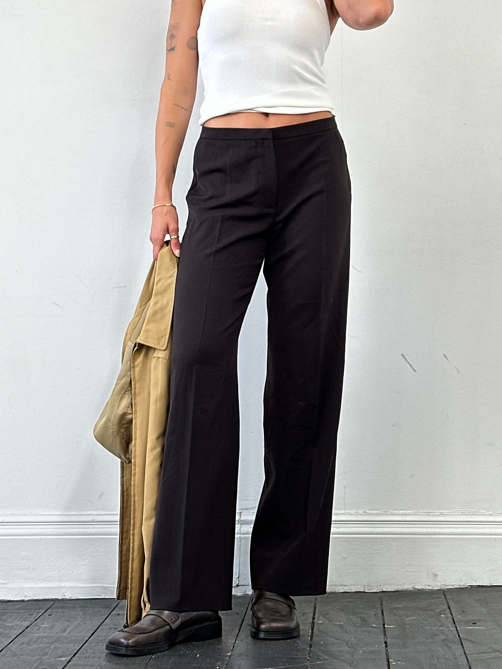 Max Mara minimal wool mid-waist tailored trousers in neutral fabric, front view showing sleek, tailored fit.