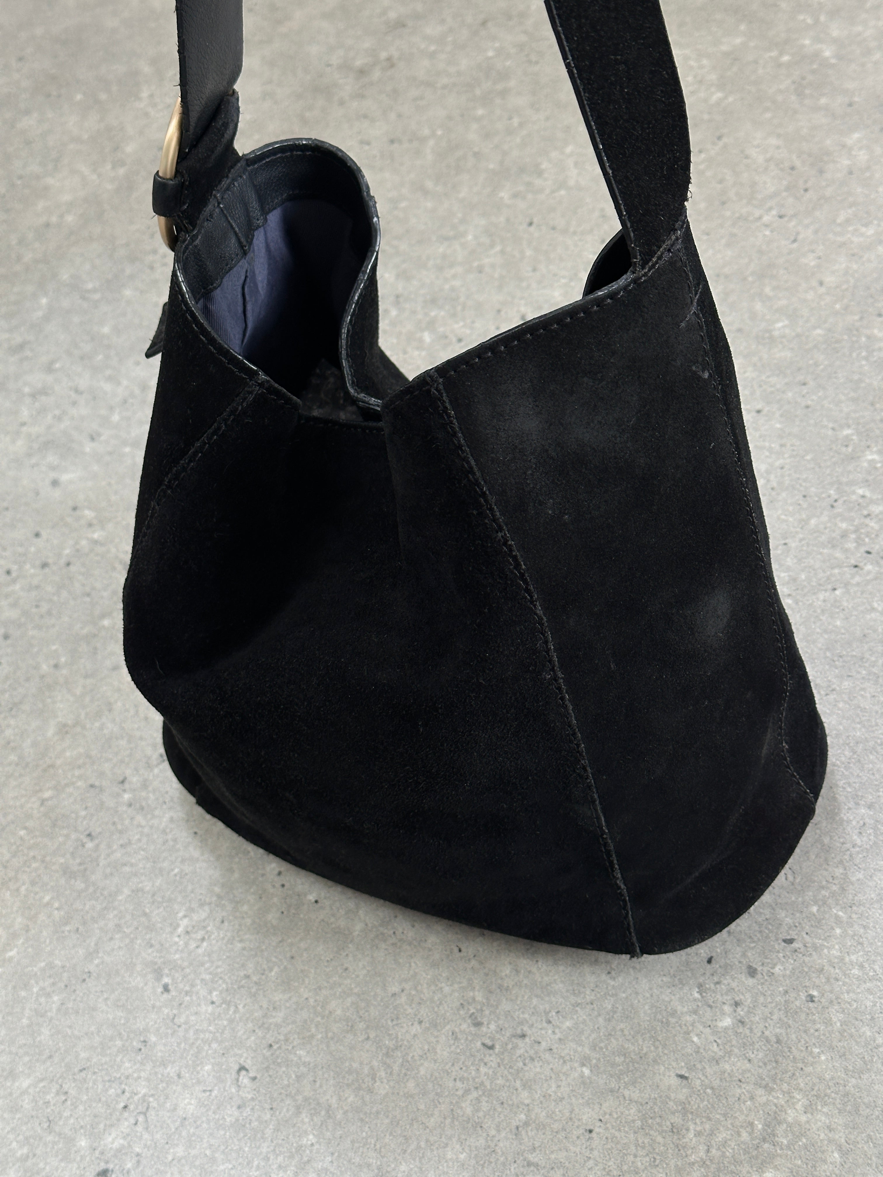 Vintage Maison de Nimes suede bucket bag with drawstring closure and shoulder strap, featuring a soft, textured surface.