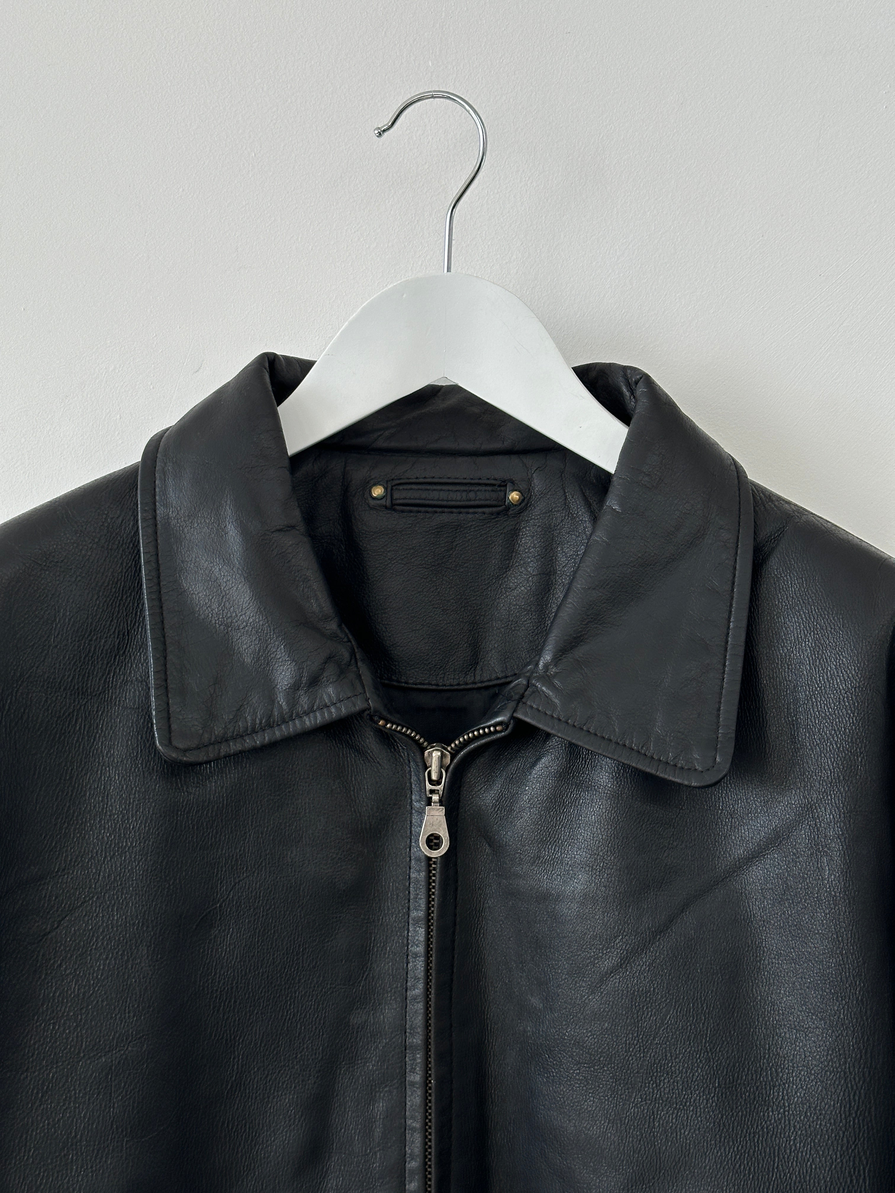 Vintage leather bomber jacket in XL size, featuring classic design with a rugged leather texture and detailed stitching.