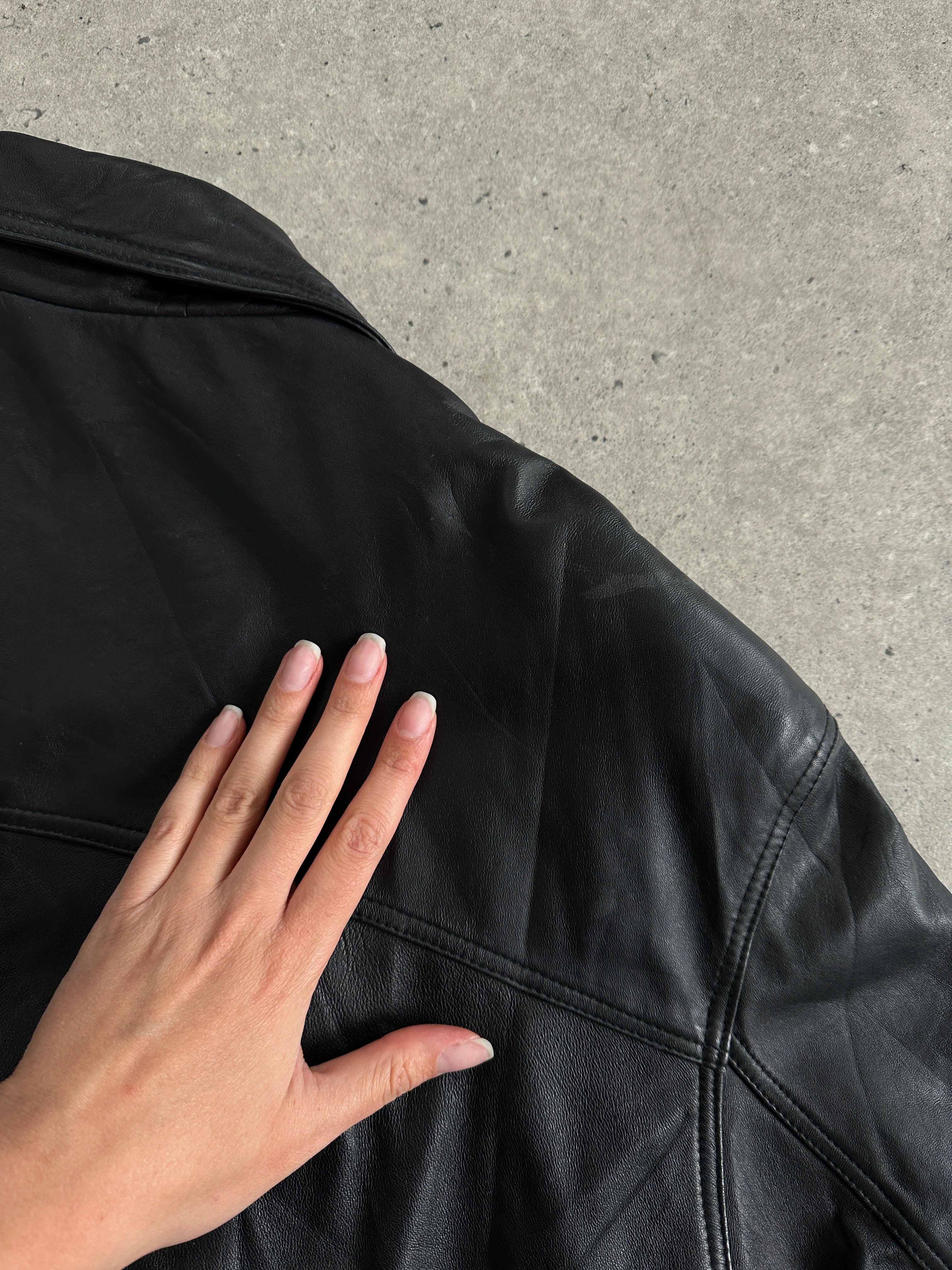 Vintage leather bomber jacket in XL size, featuring classic design with a rugged leather texture and vintage style.