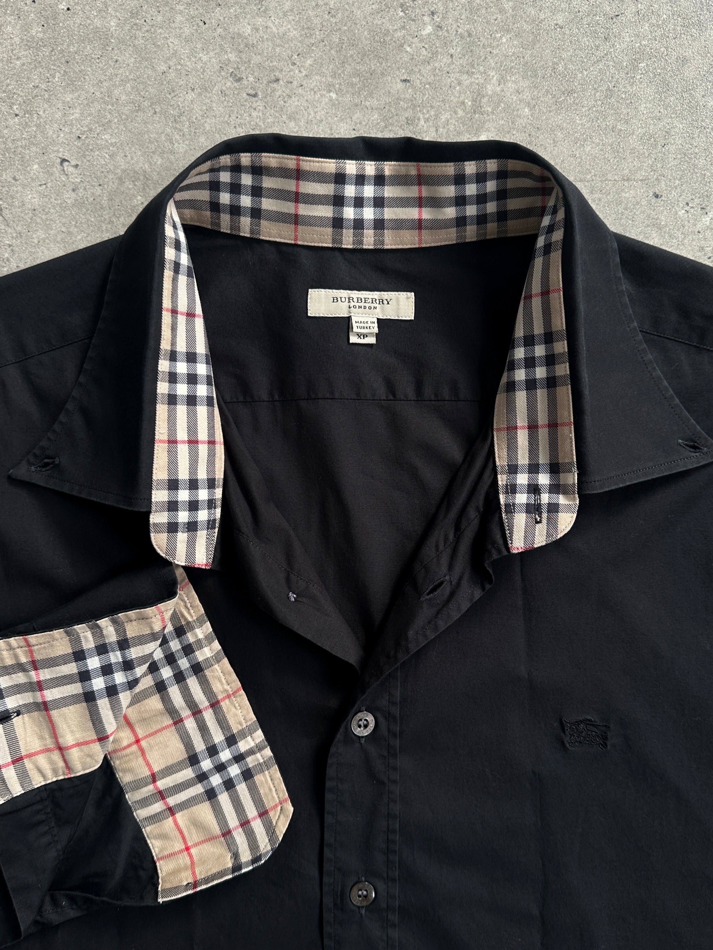 Burberry London pure cotton logo shirt in XL displayed on a hanger showing the front design and classic collar.