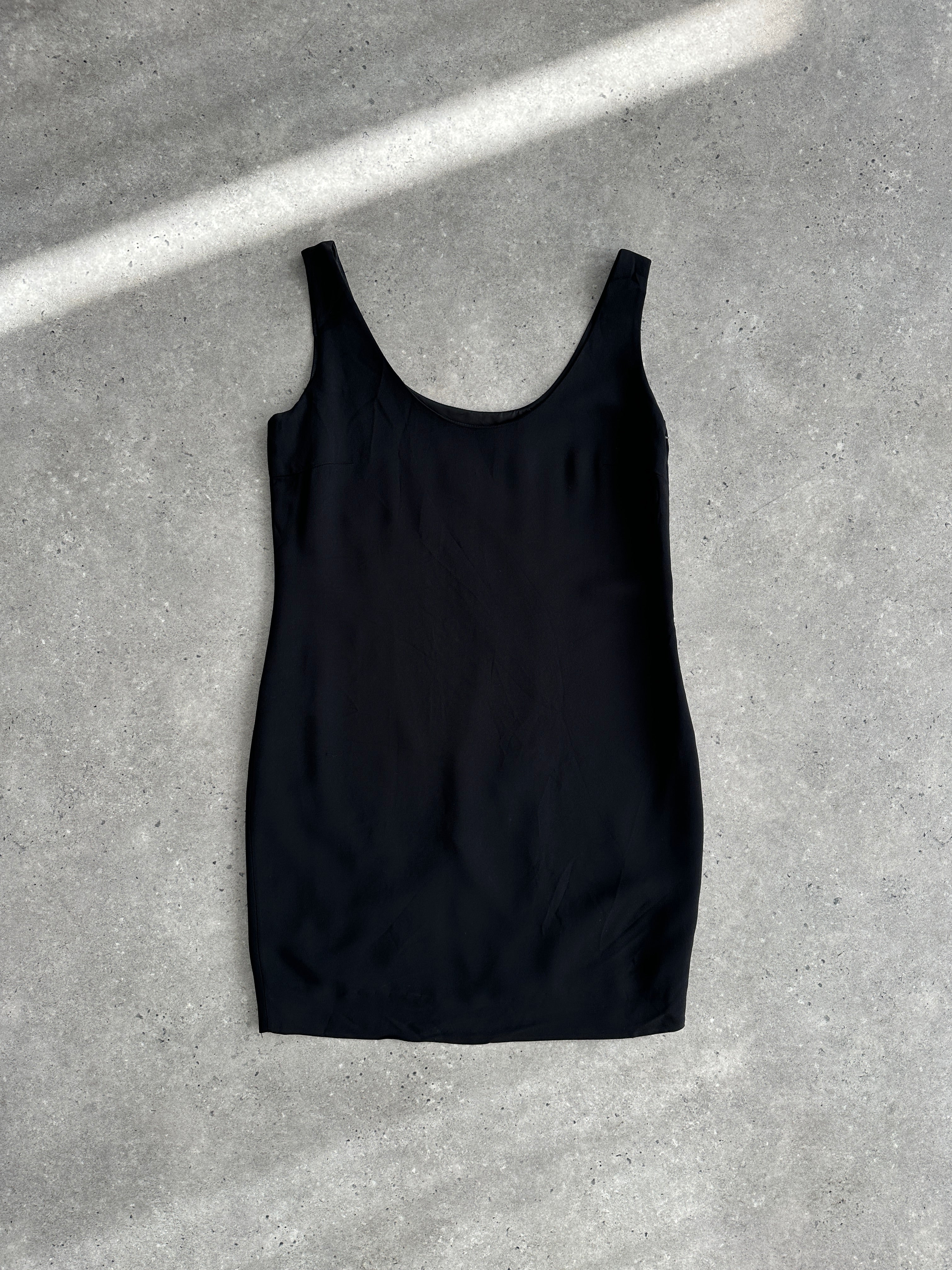 Moschino Couture fitted mini dress in a sleek design, shown on a mannequin with bold fashion details.