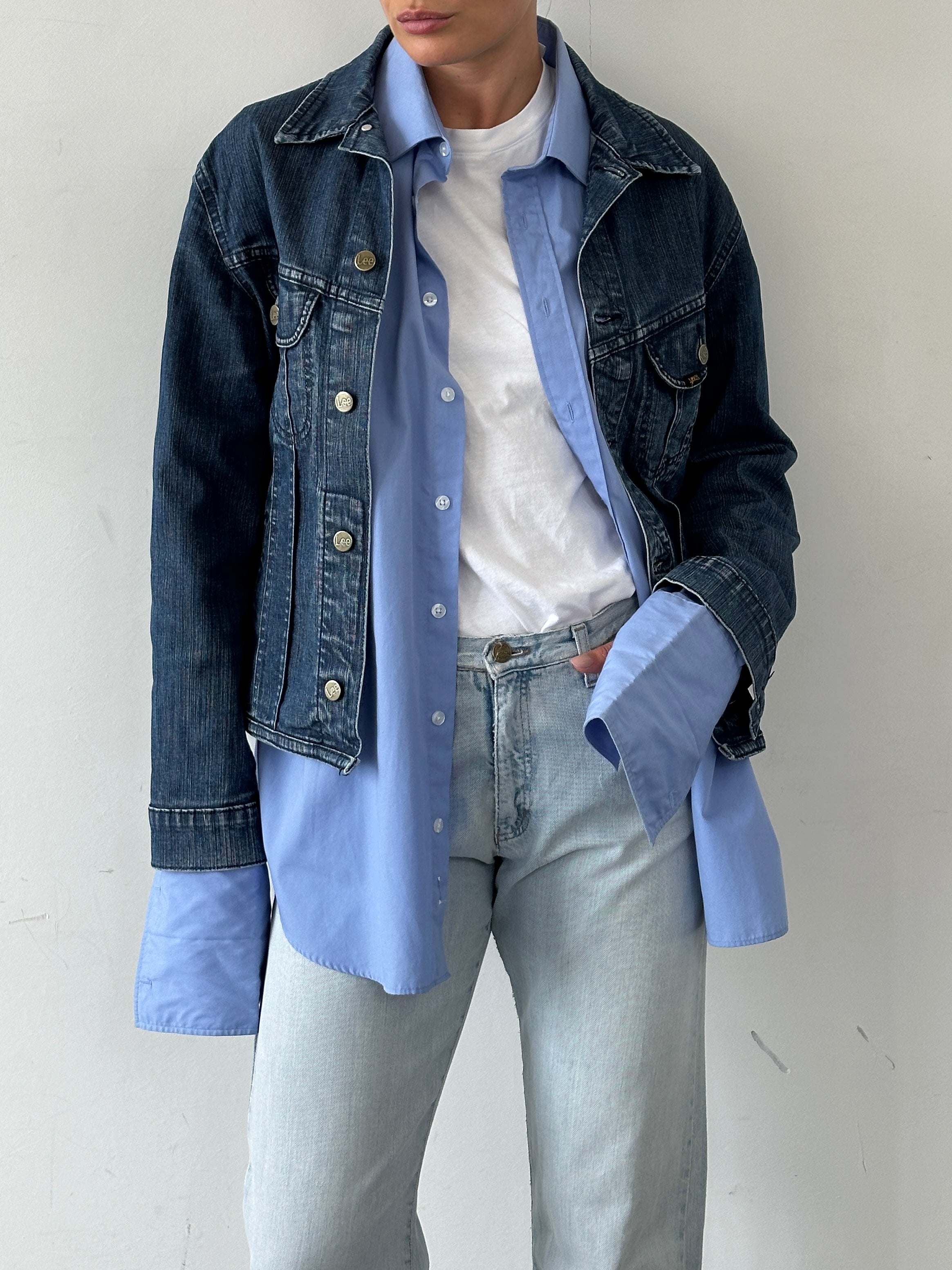 Lee cotton fitted denim jacket in medium size, shown on a hanger with classic blue denim fabric and button details.