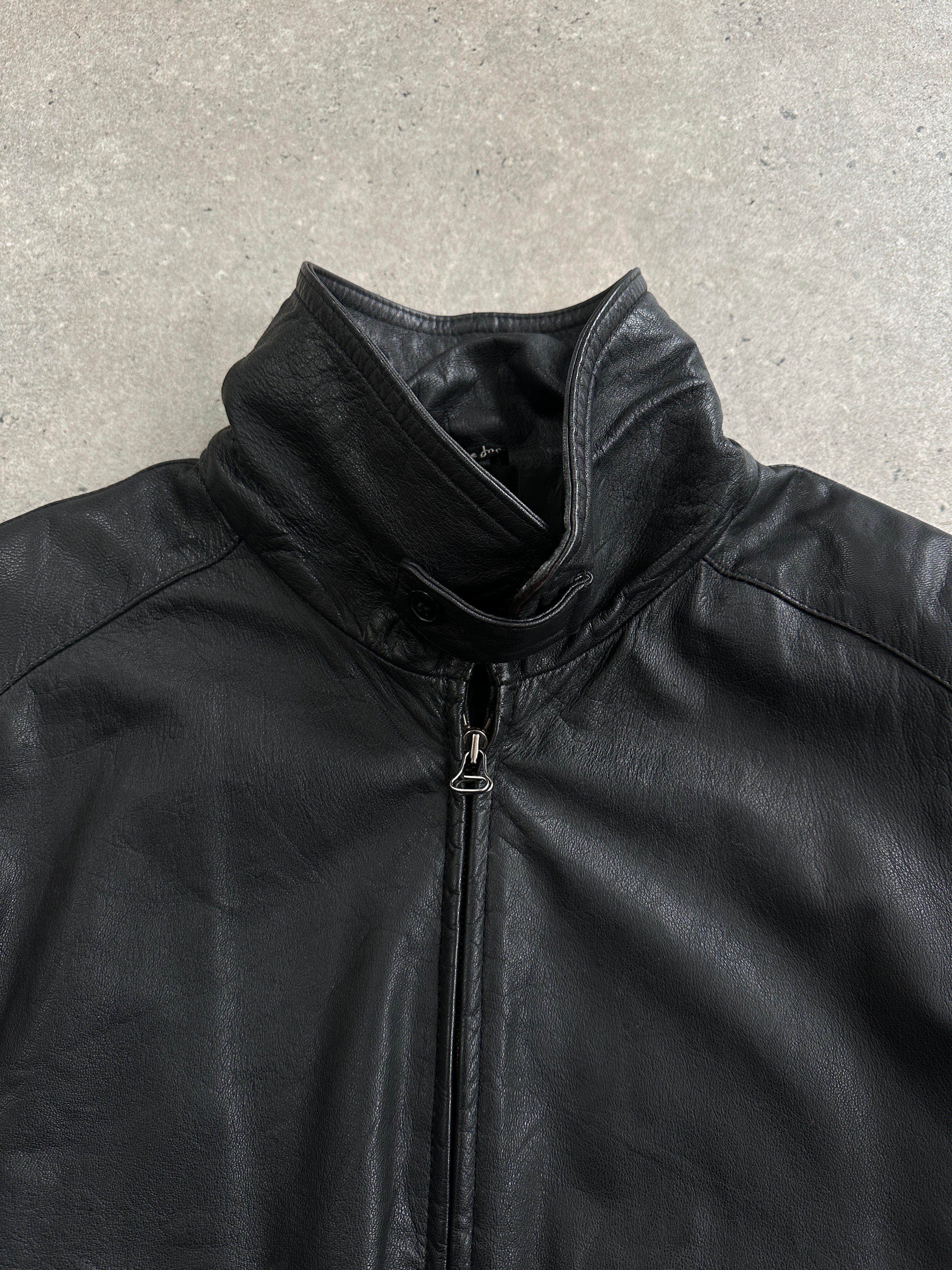 Vintage 1980s high neck leather bomber jacket in black, featuring classic design and metal zipper details.