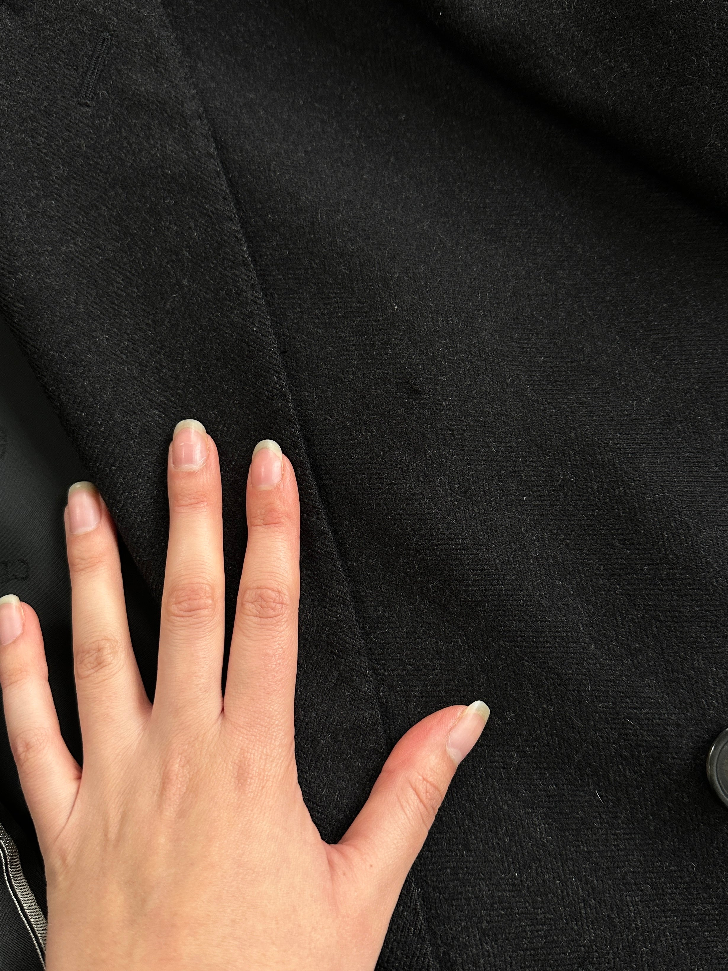 Christian Dior pure wool double-breasted coat in size L/XL, showcasing classic design and tailored fit with lapel collar and button details.
