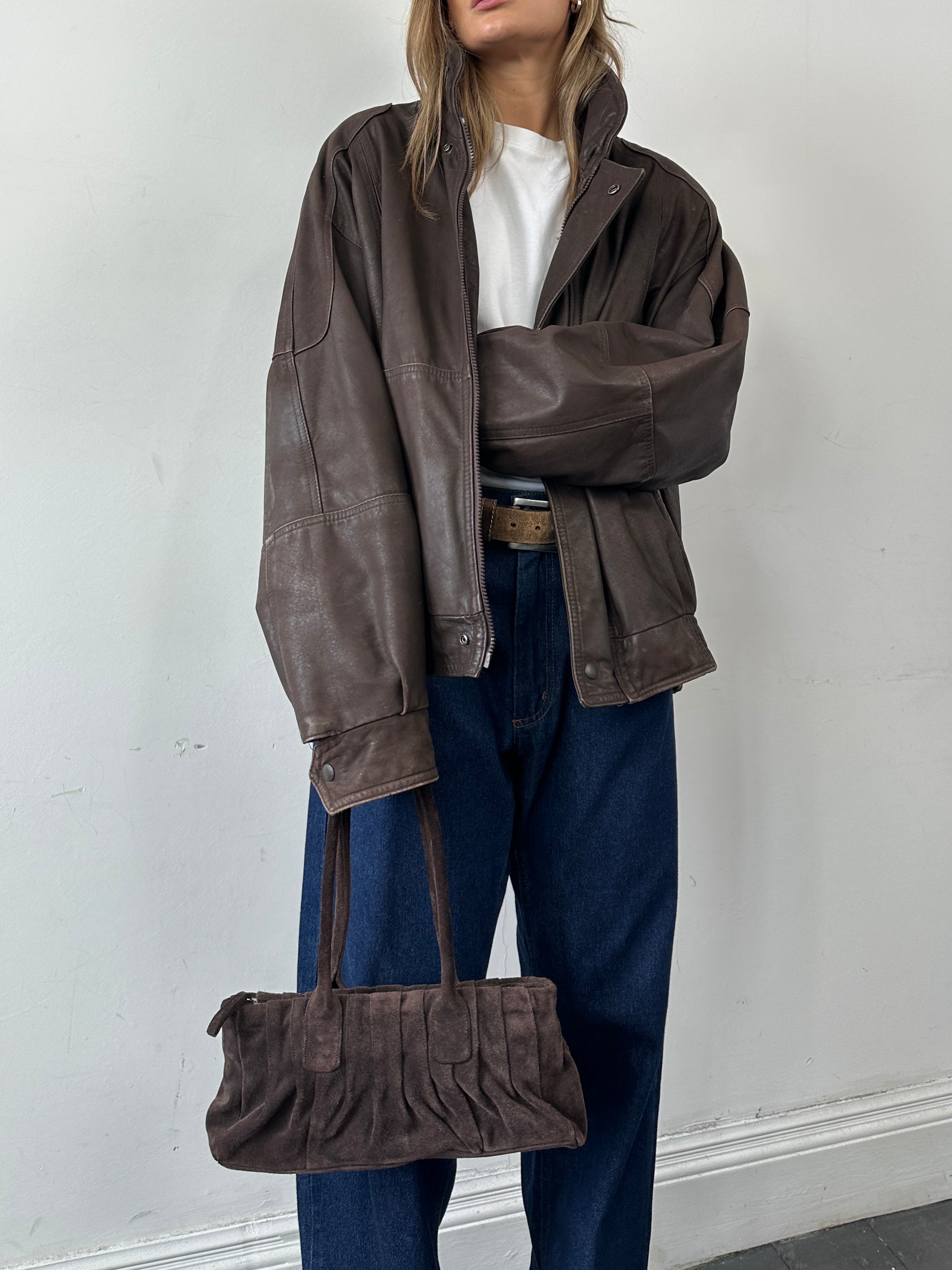 Vintage leather bomber jacket in XL size, featuring classic design and rugged texture, perfect for casual and stylish wear.