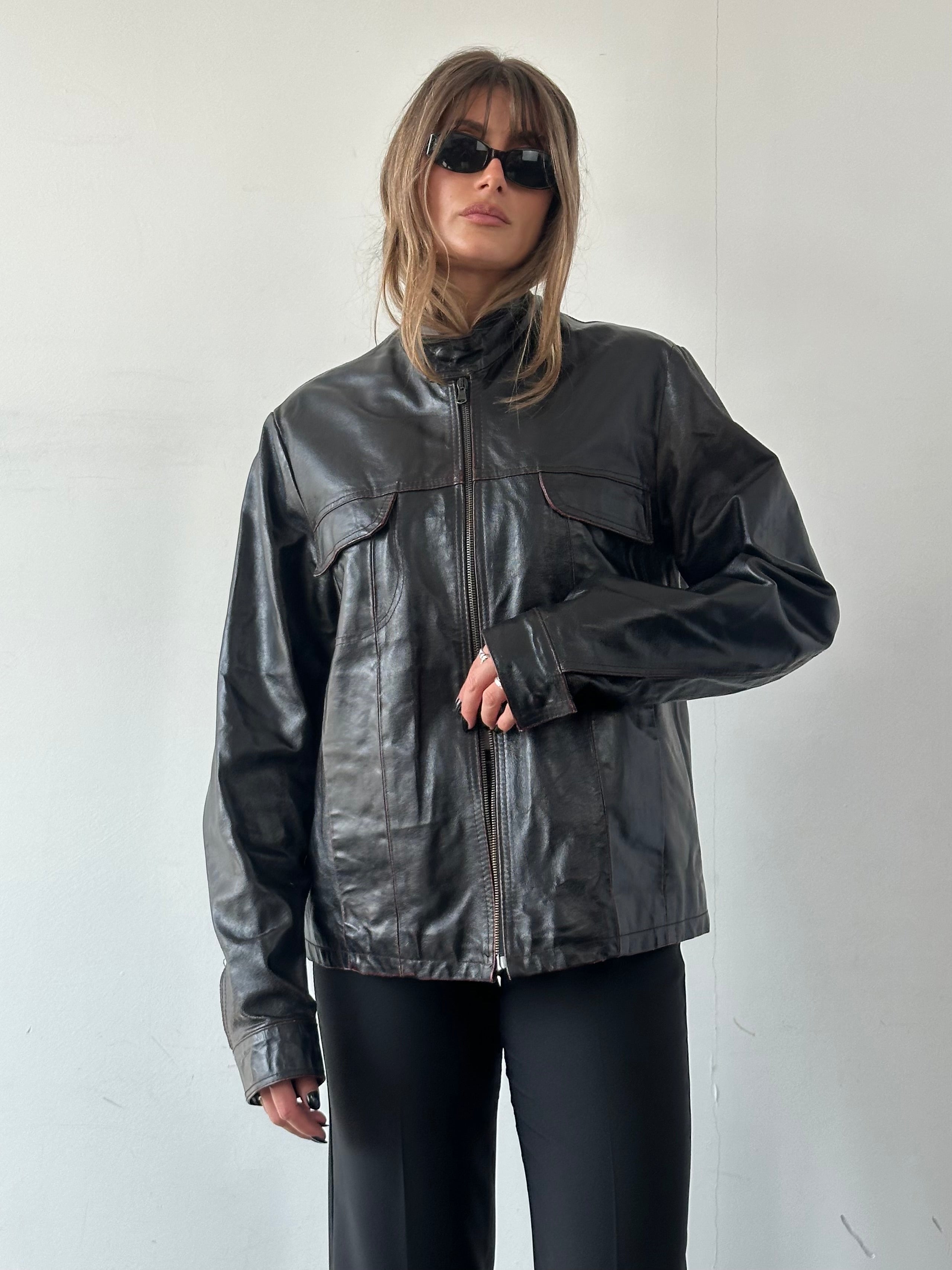 Vintage Italian distressed leather jacket with double zippers, featuring a rugged, vintage style in size L/XL.