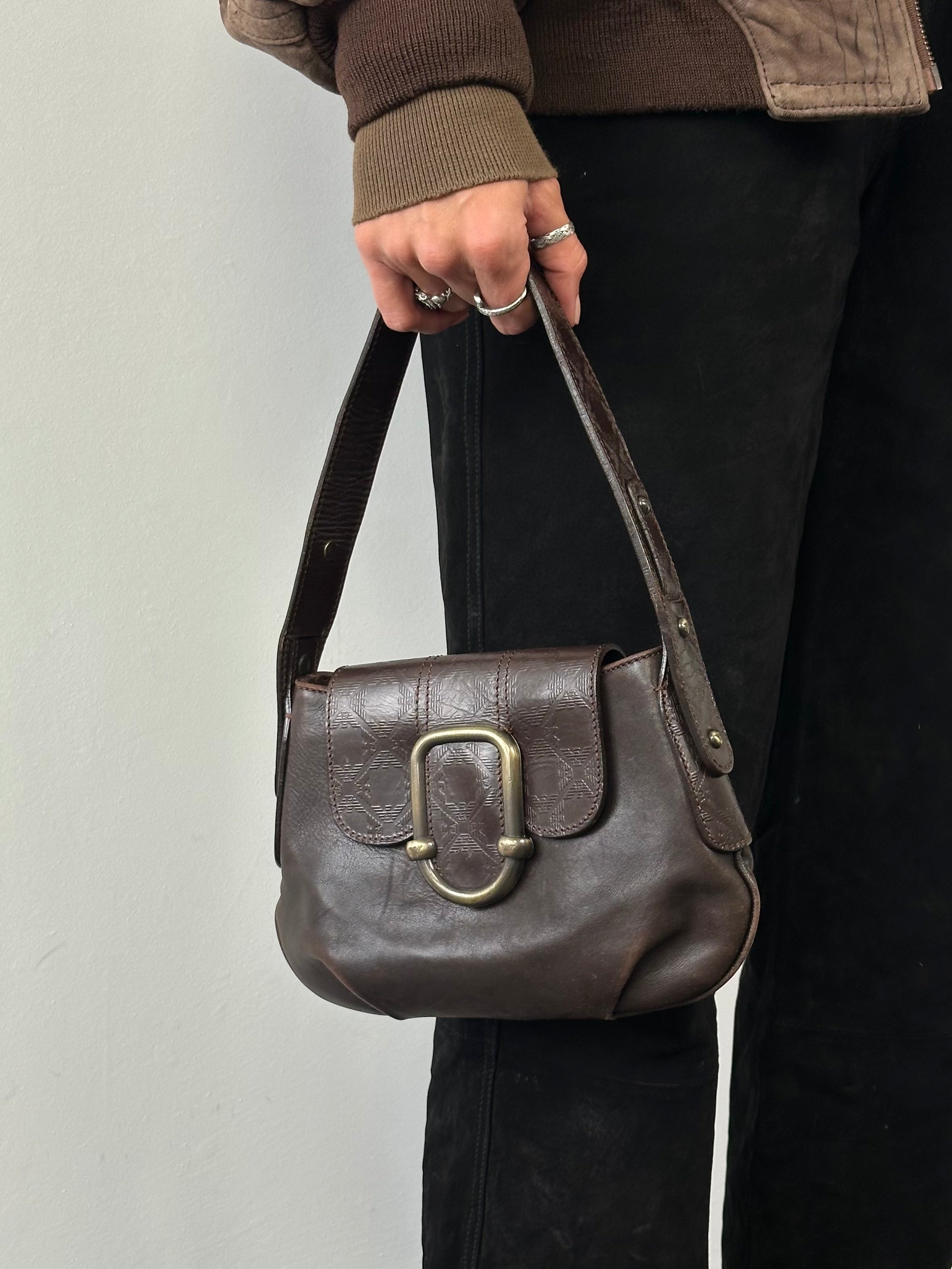 Emporio Armani leather shoulder bag with hardware monogram design, featuring a sleek strap and elegant style.