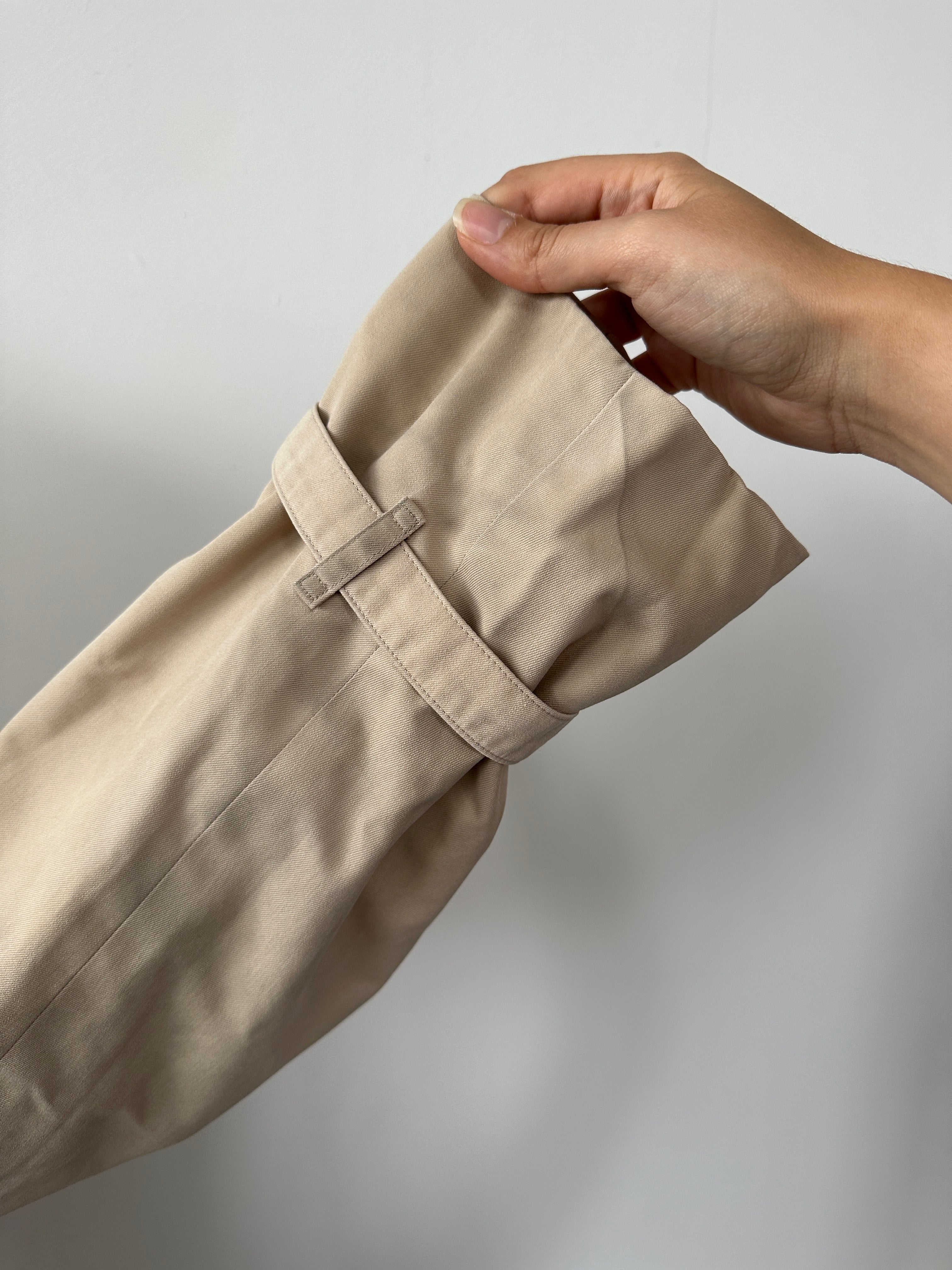 Burberry double-breasted trench coat in XL size, beige color, classic design with belt and button details, displayed on a hanger.