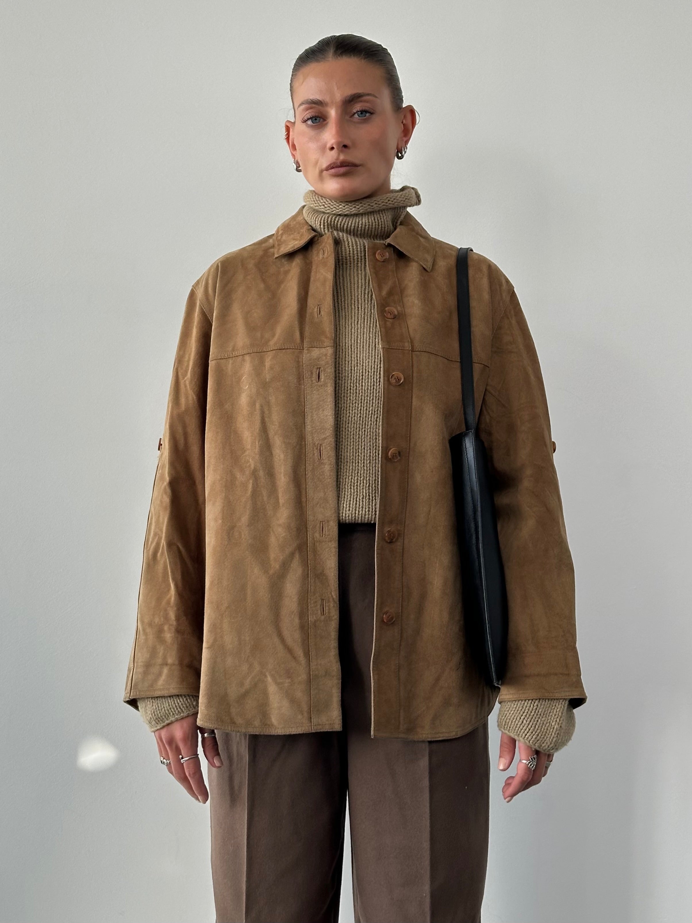 Vintage suede shirt in size large, with a classic design and soft textured fabric, shown in a natural pose.