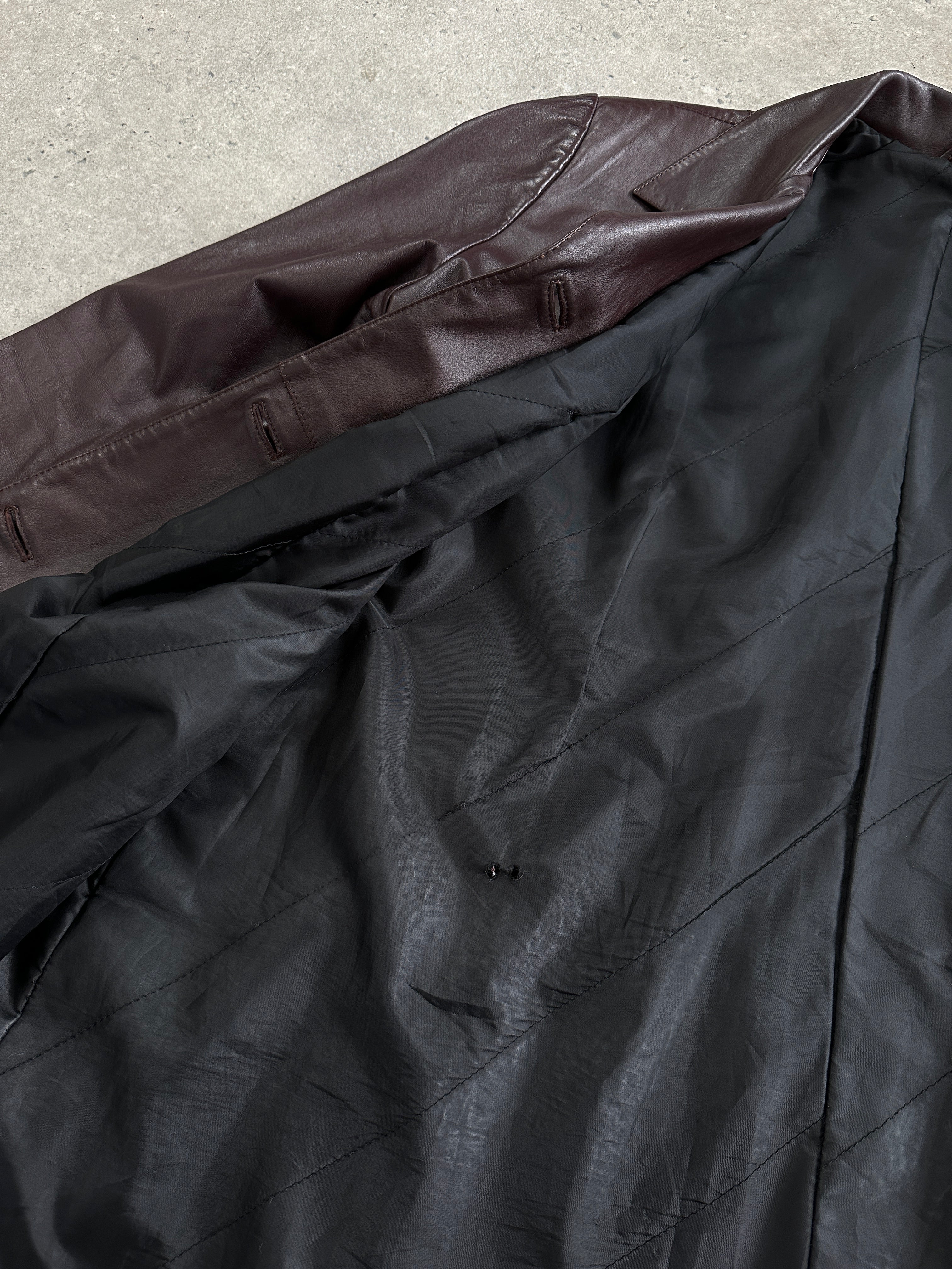 Vintage leather trench coat jacket in size L, featuring classic design and aged leather finish, displayed on a hanger.