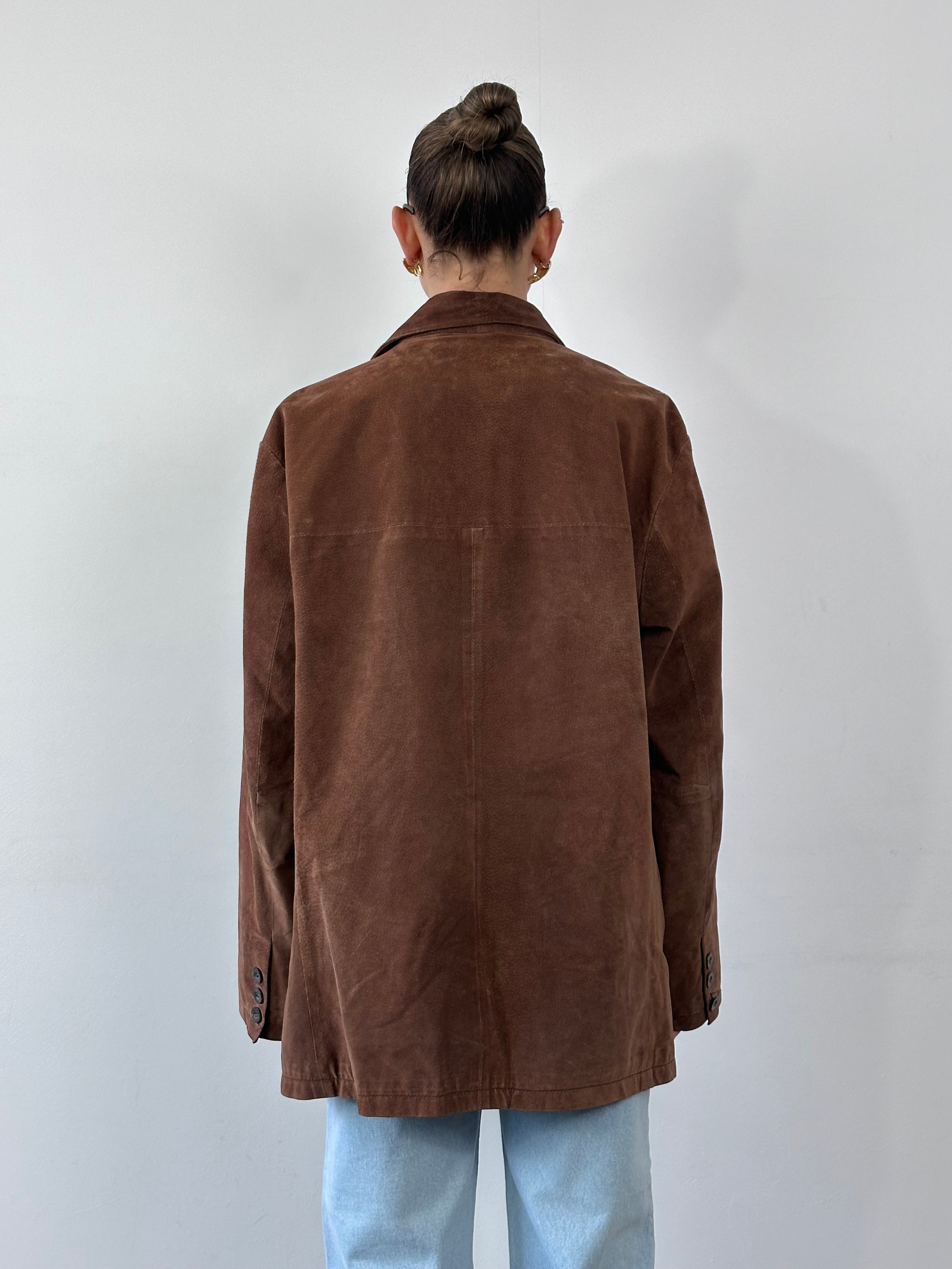Vintage suede leather jacket in XL size, featuring classic design and soft texture, displayed on a hanger.