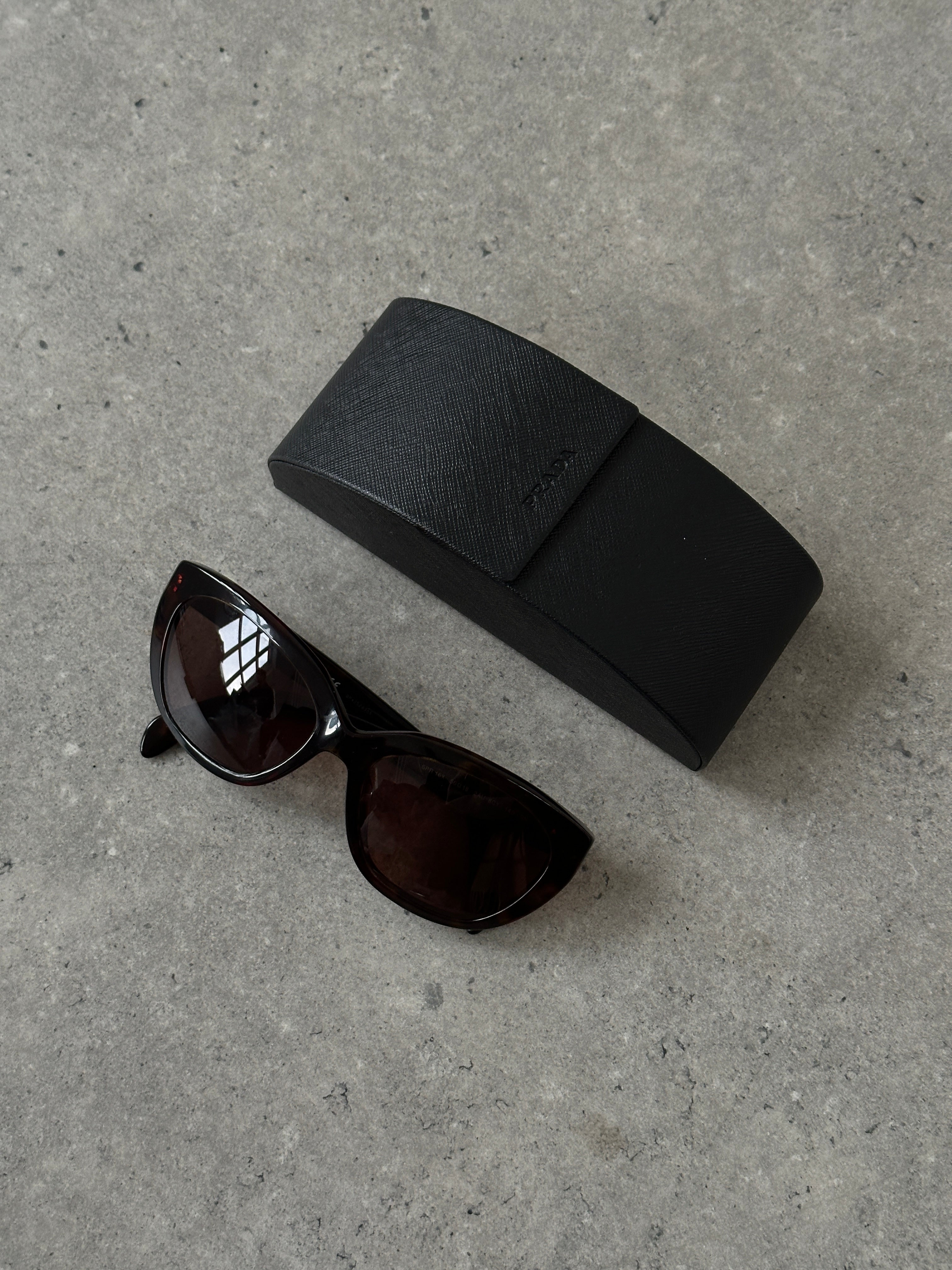 Prada tortoise shell round logo sunglasses with sleek frames and dark lenses, stylish and iconic eyewear accessory