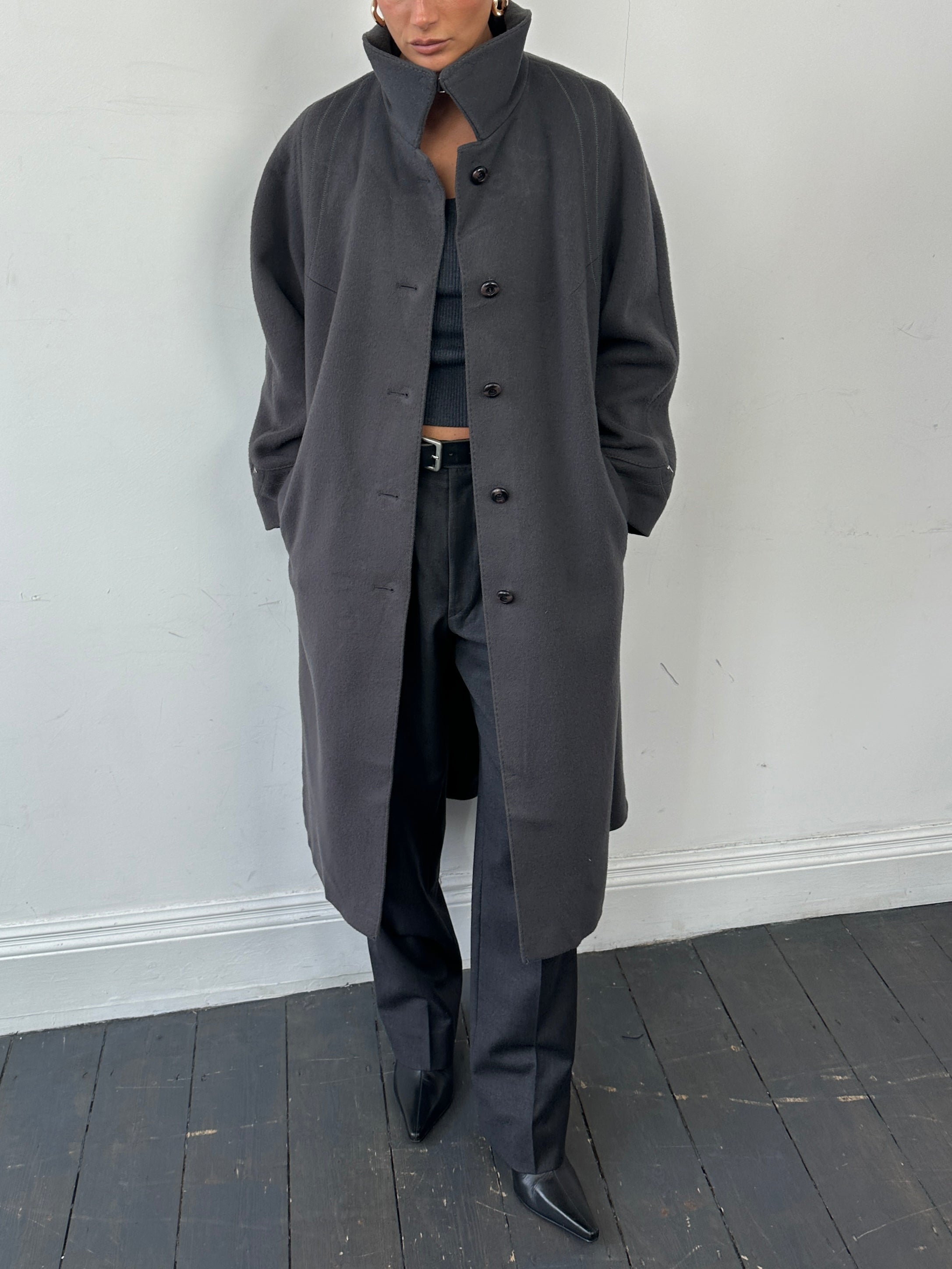Vintage brand wool single-breasted coat in size M, featuring classic design and textured fabric, displayed on a hanger.
