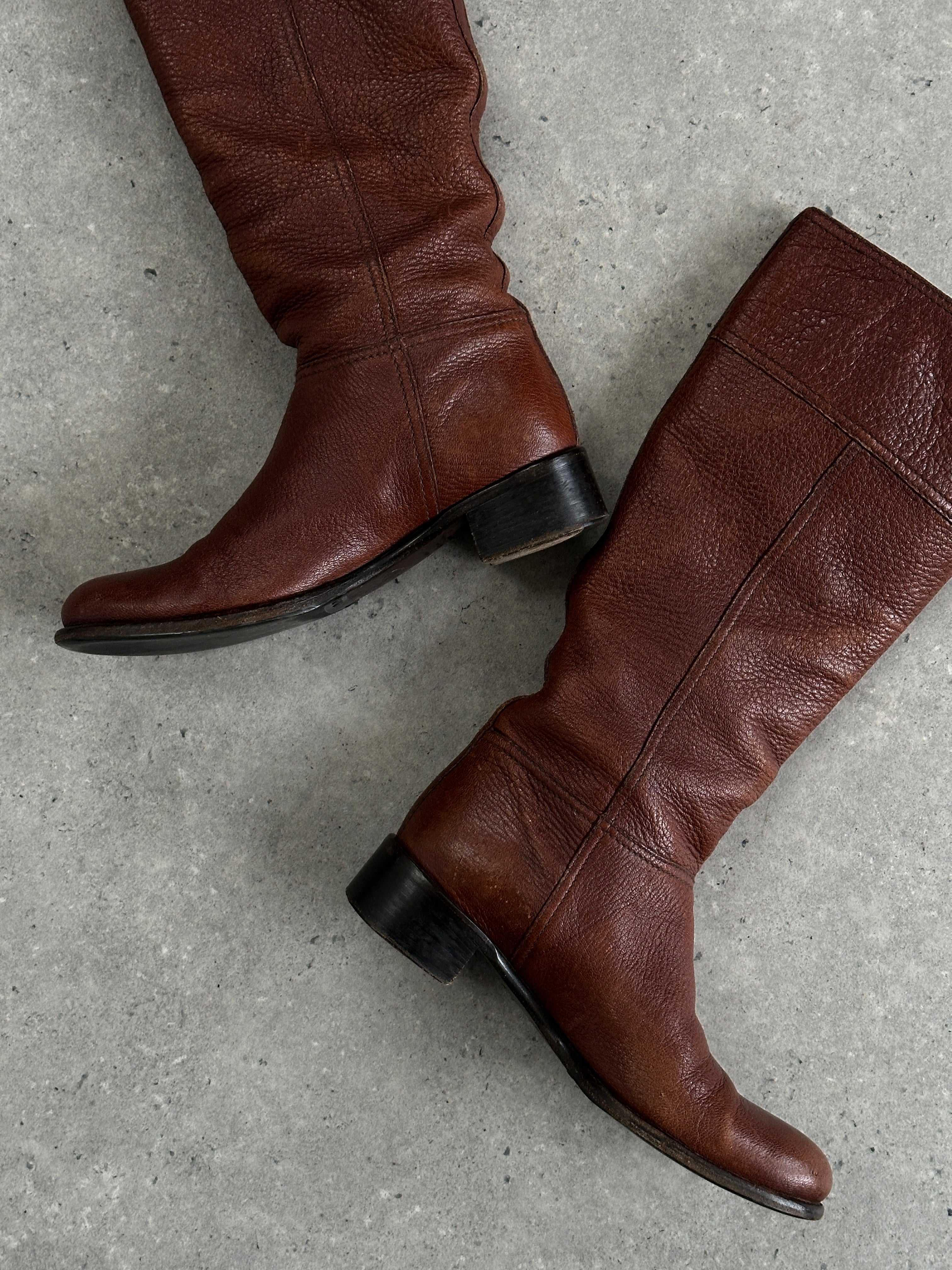 Prada leather knee boots in black with logo detail, UK size 4, stylish and sleek footwear for fashionable wear.