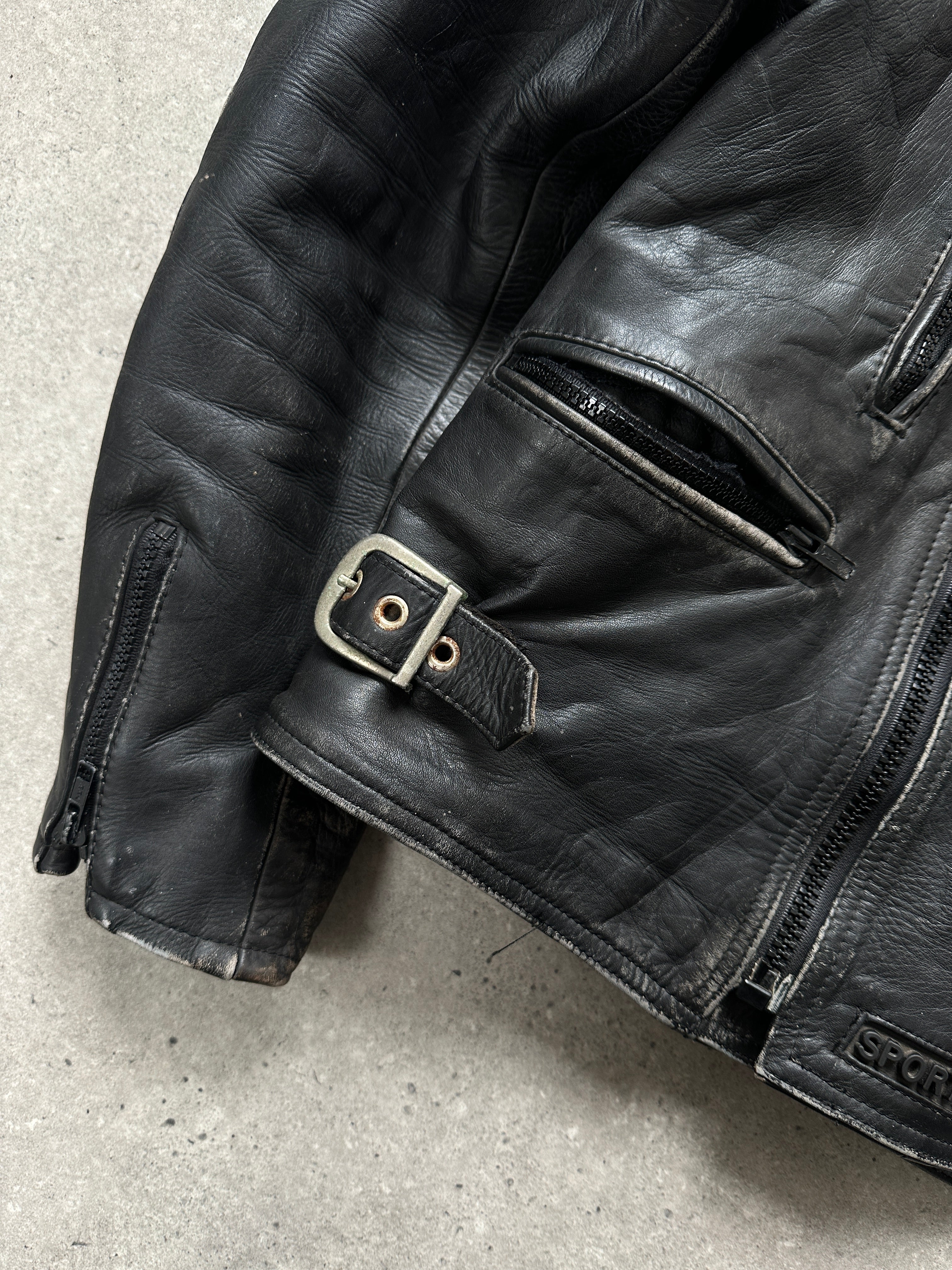 Vintage distressed motorcycle leather jacket in size L/XL, featuring rugged design and classic biker style.