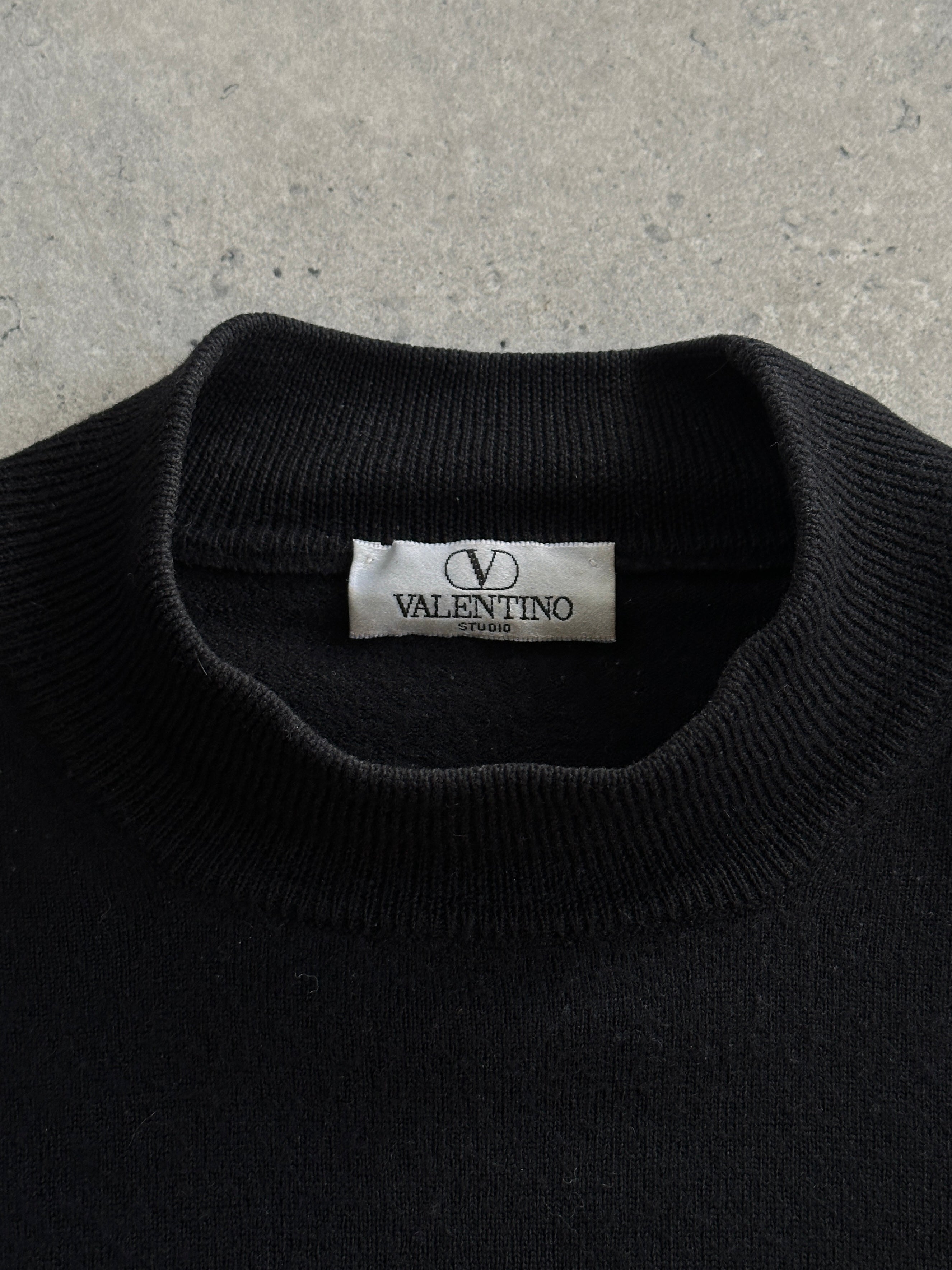 Valentino pure wool logo turtleneck jumper in black, featuring a high neckline and subtle brand logo detail, in size M/L.