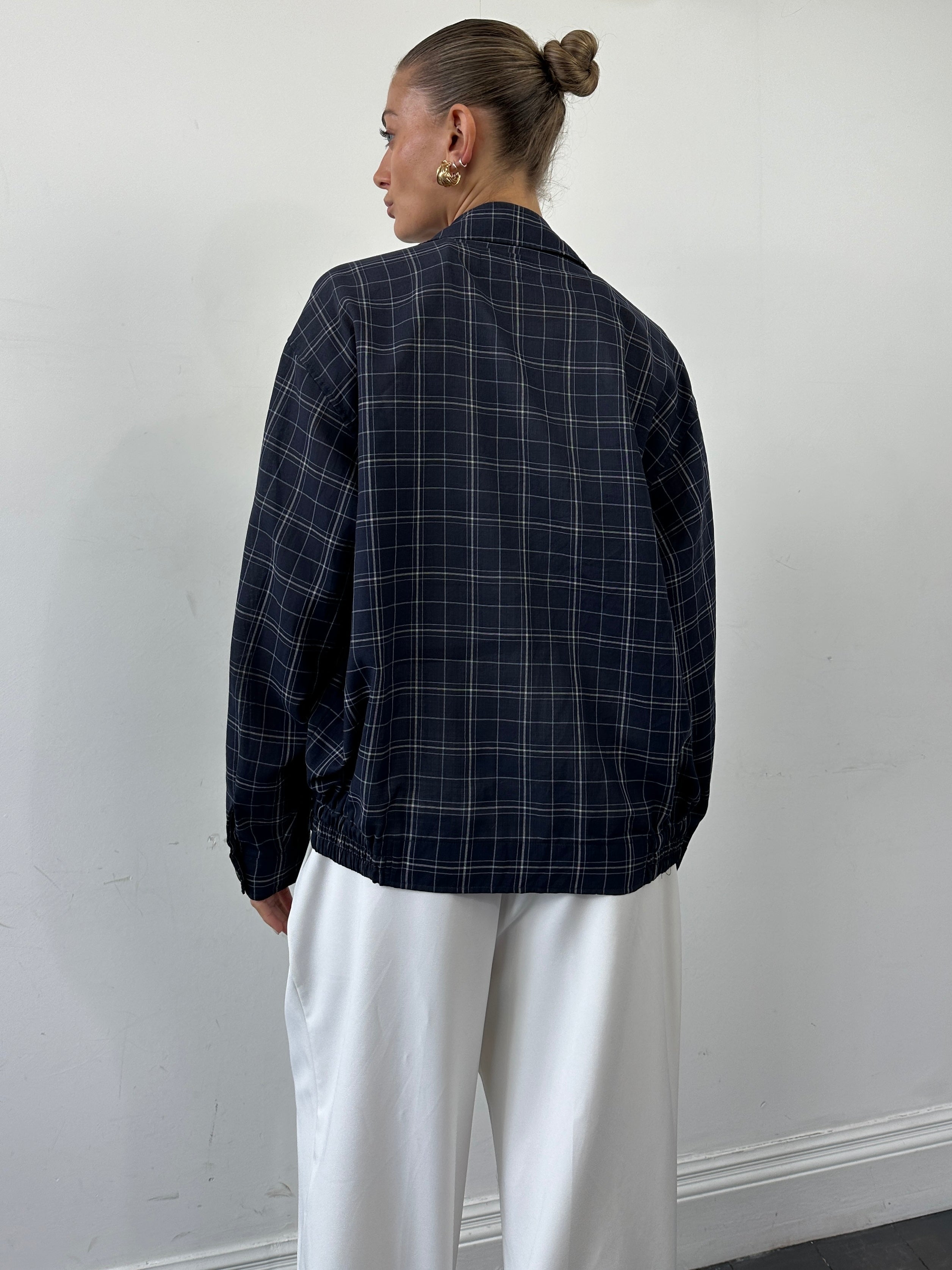Yves Saint Laurent Pour Homme check logo bomber jacket in size L, black with logo pattern and ribbed cuffs.