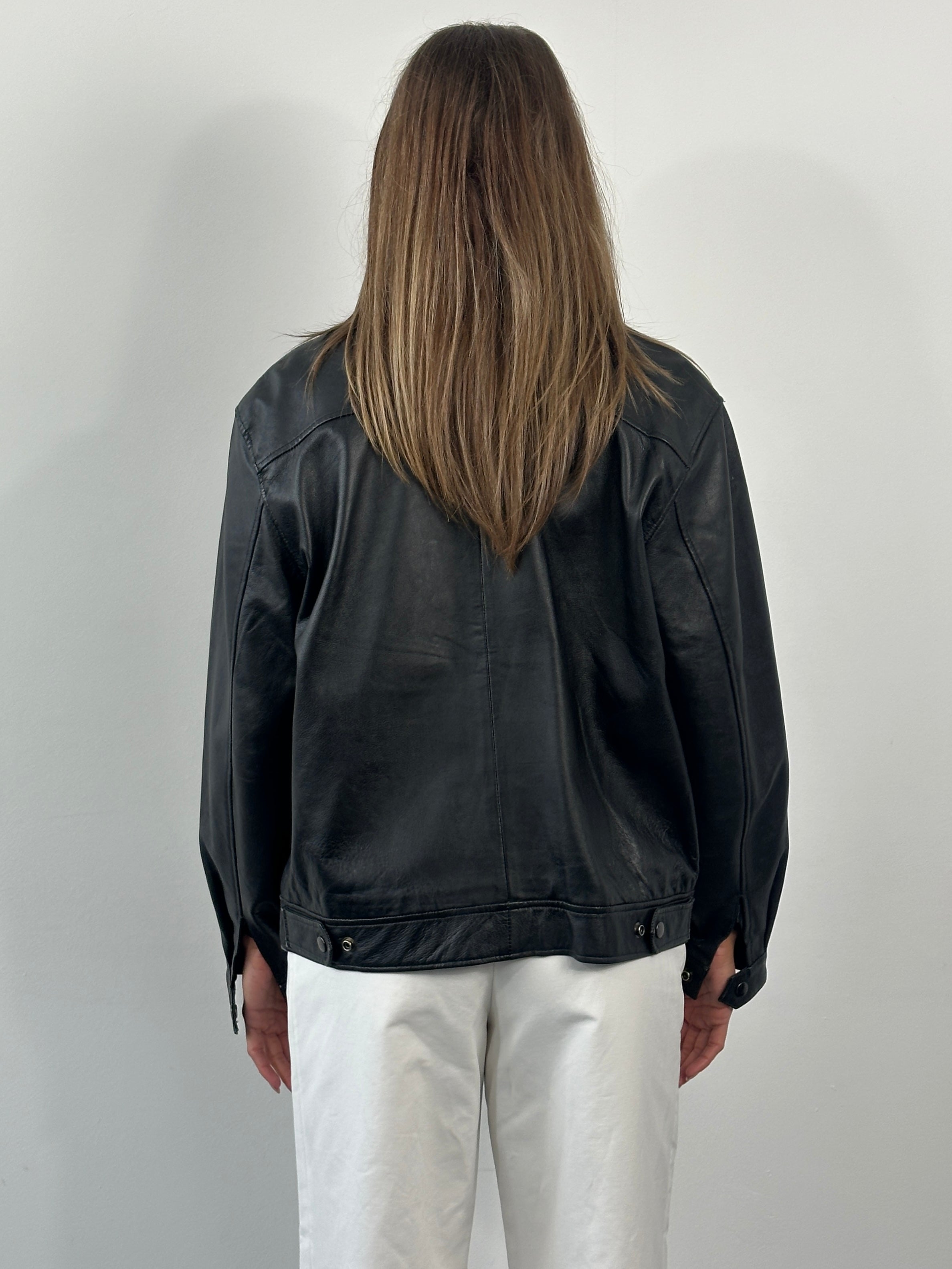 Vintage 1990s leather bomber jacket, S/M size, classic black leather with ribbed cuffs and collar, vintage men's fashion piece.