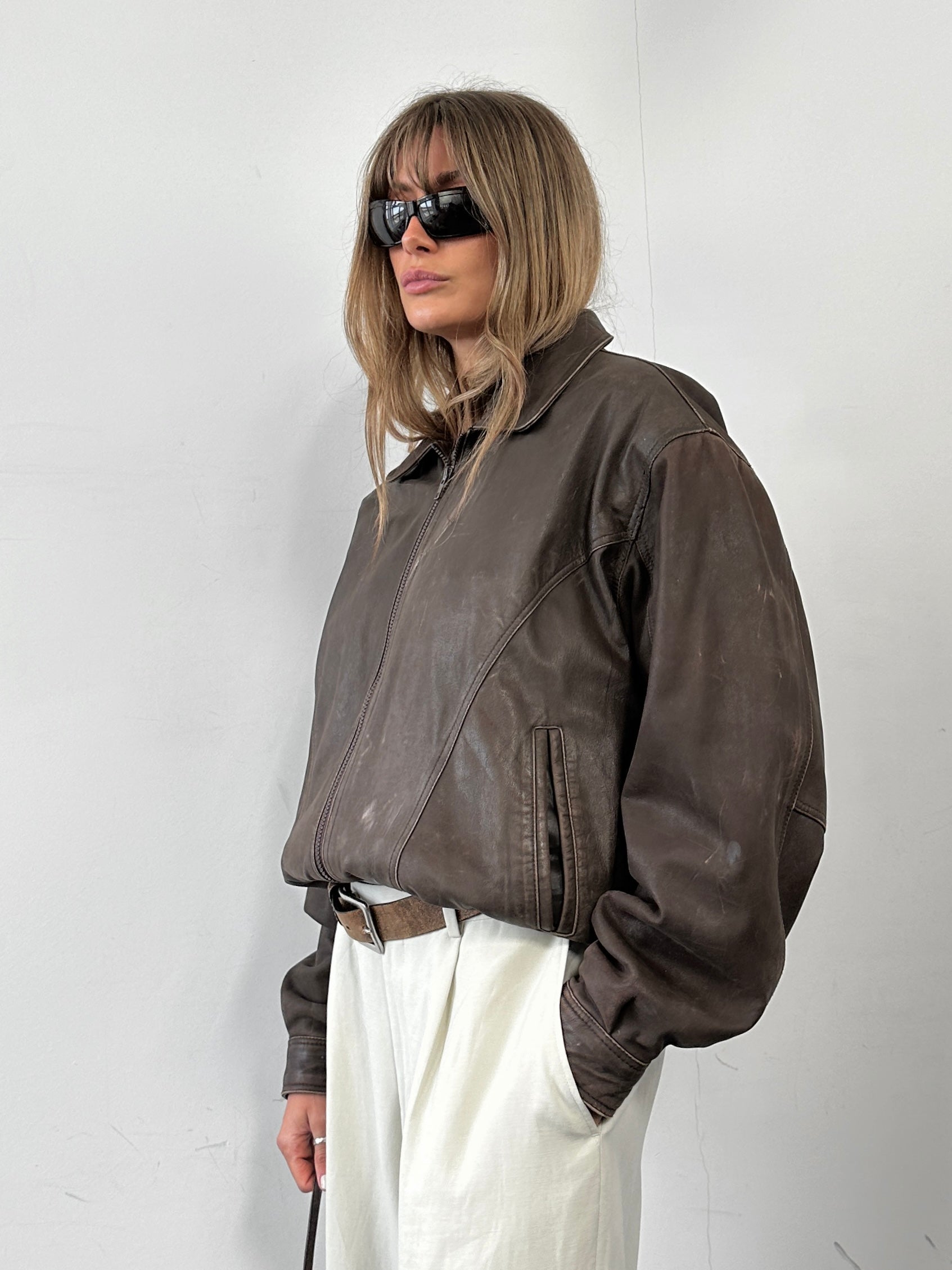 Vintage distressed leather bomber jacket, size M, featuring rugged style and classic design.