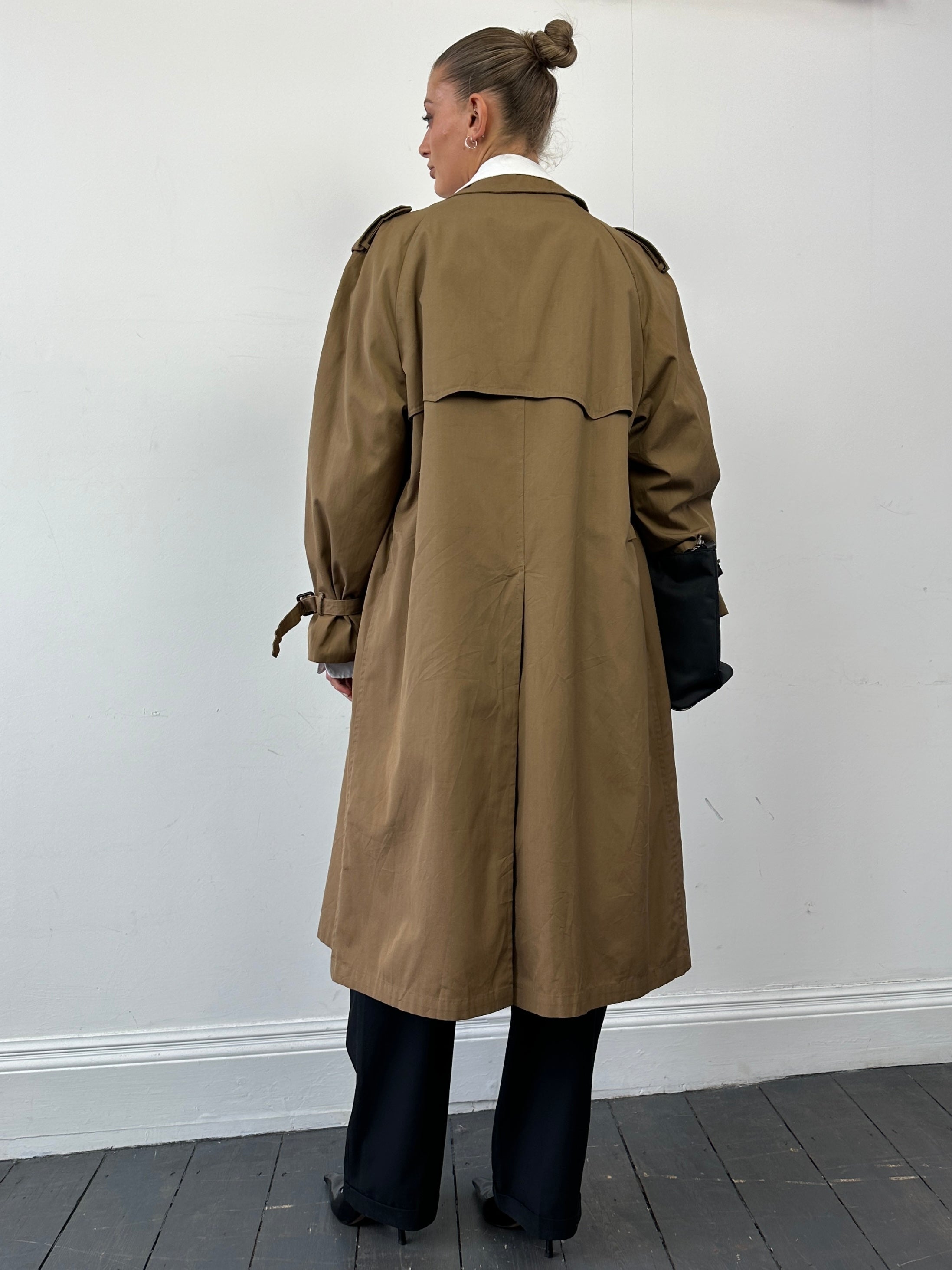 Christian Dior cotton double-breasted trench coat in size L displayed on a hanger, showcasing classic beige design and tailored fit.