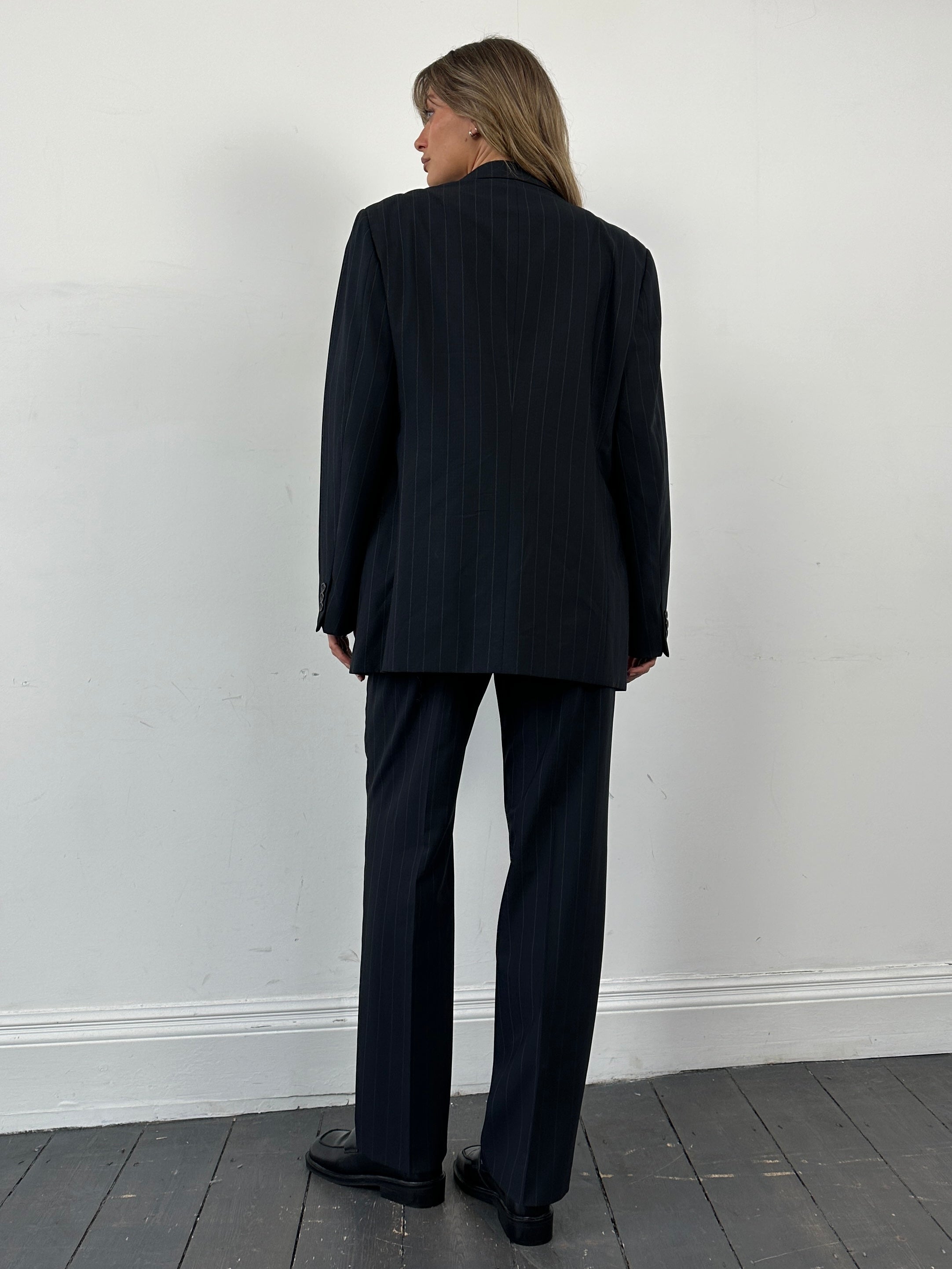 Armani Collezioni pinstripe wool single-breasted suit in size 38R/W32, displayed on a hanger.
