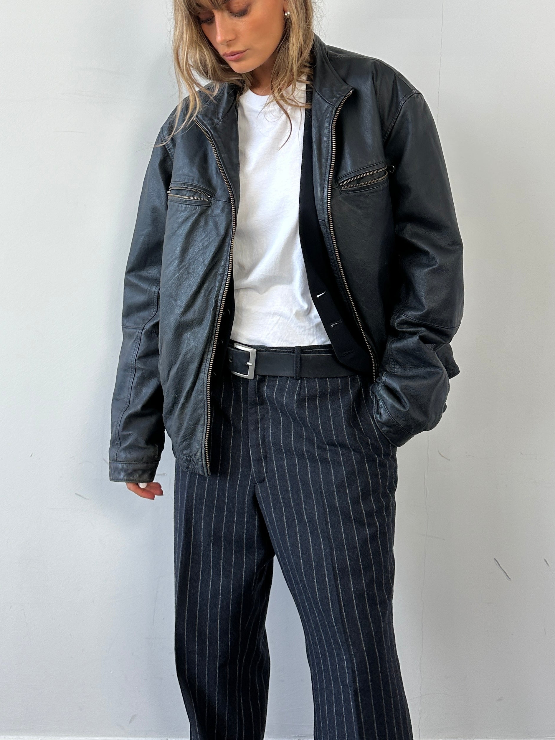Vintage zip-up leather jacket, size large, featuring classic design and durable leather material.