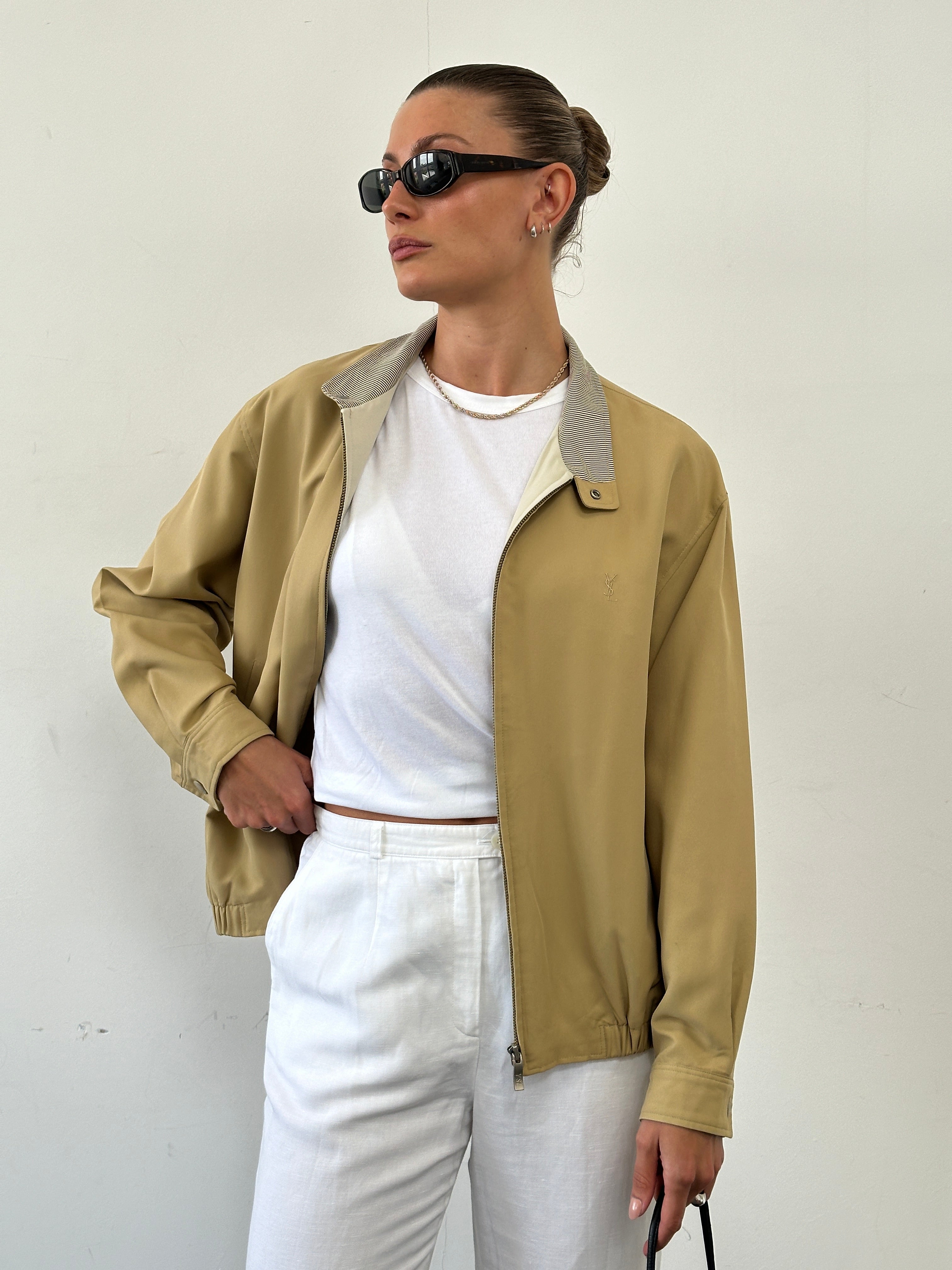 Yves Saint Laurent logo bomber jacket in black, front view showing the designer branding and classic fit for men and women.