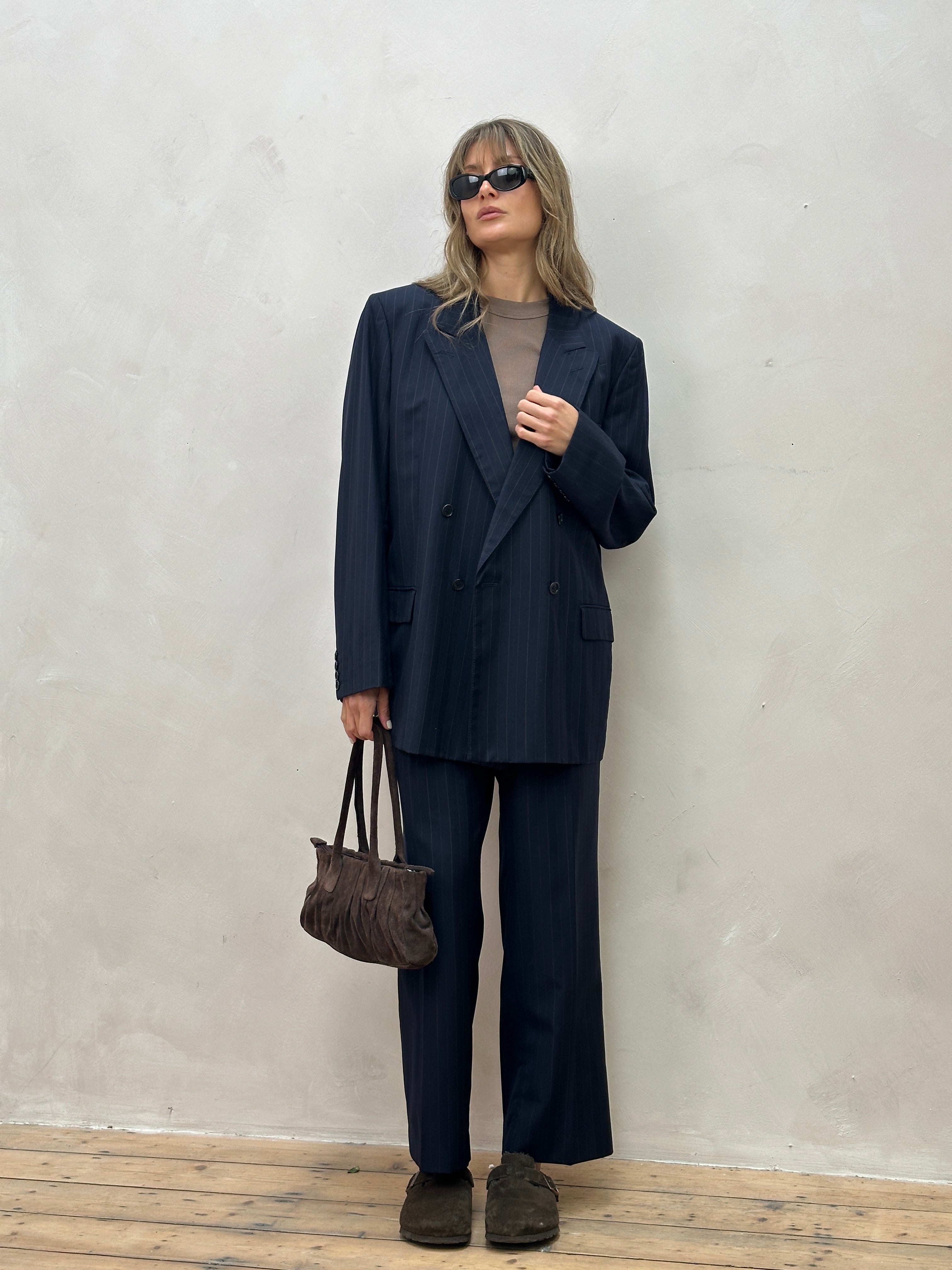 Christian Dior pinstripe wool jumpsuit with double-breasted design, size 44R/W34, featuring tailored lapels and a sleek fit.