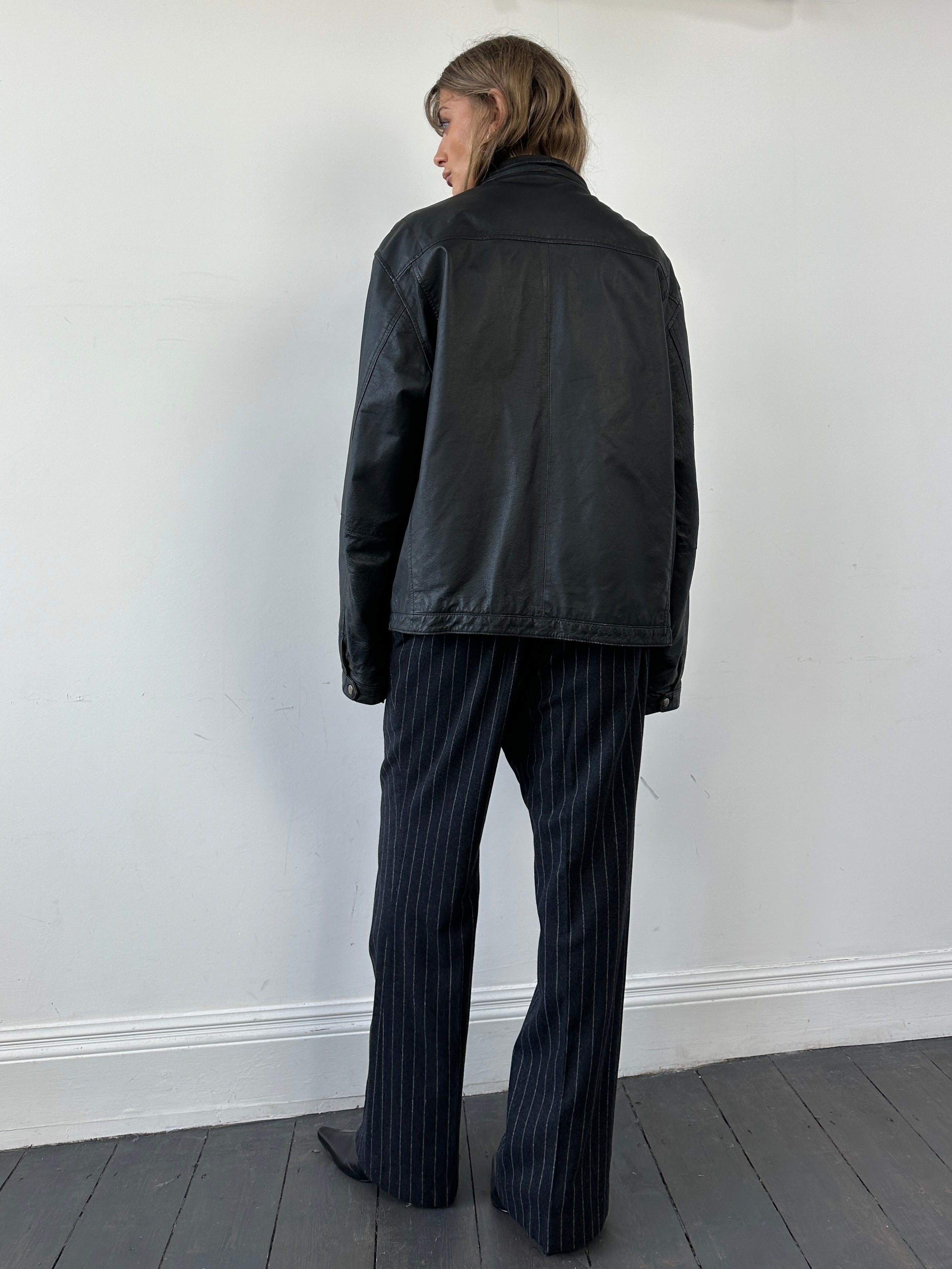 Vintage brand vintage zip-up leather jacket in size L, front view showing classic design and leather texture.