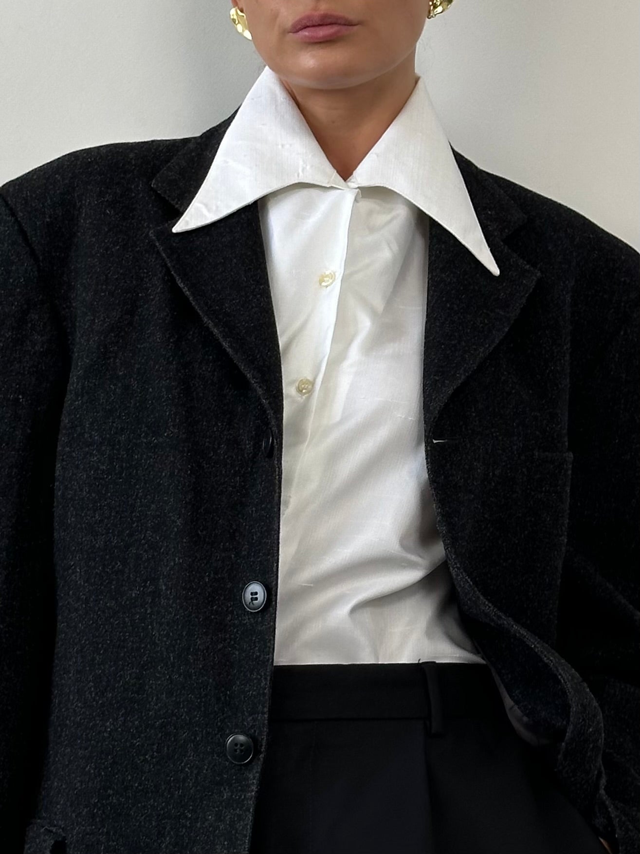 Vintage 1970s dagger collar shirt in black with long sleeves and button-up front, styled with a retro, classic look.