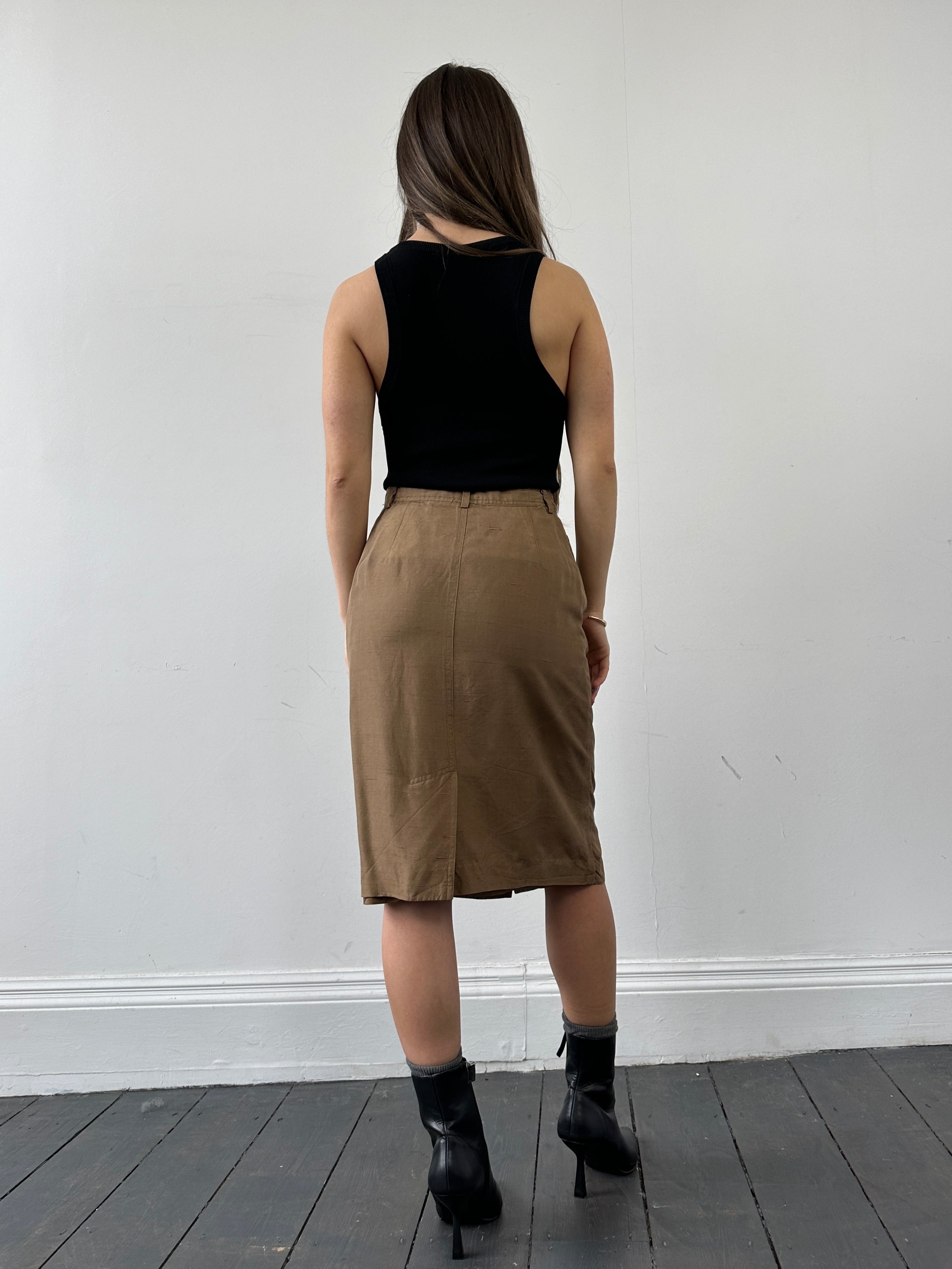 Jaeger pure silk button-down midi skirt in W24, featuring a sleek design and elegant button details, shown in a neutral color.