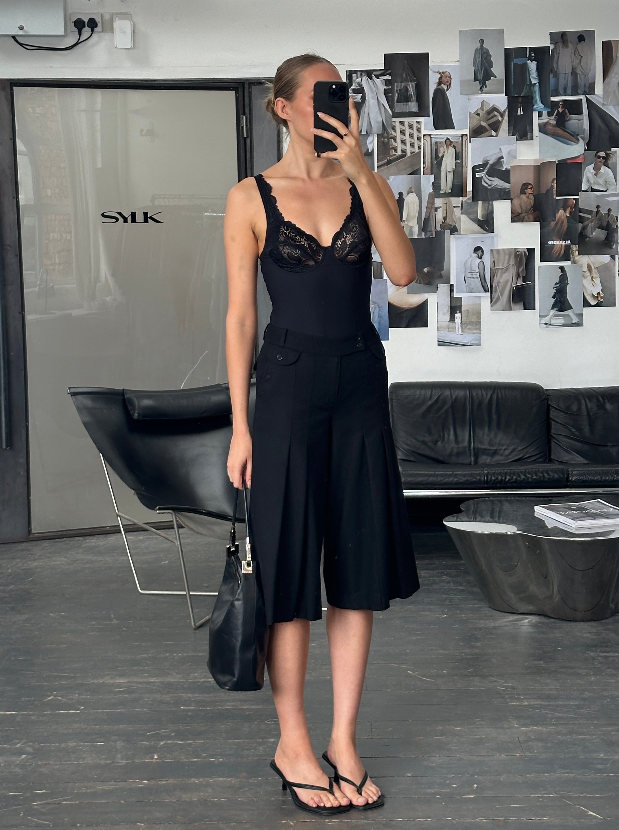 Vintage 1990s wool pleated culottes shorts in a classic style, featuring wide legs and high waist, on a neutral background.
