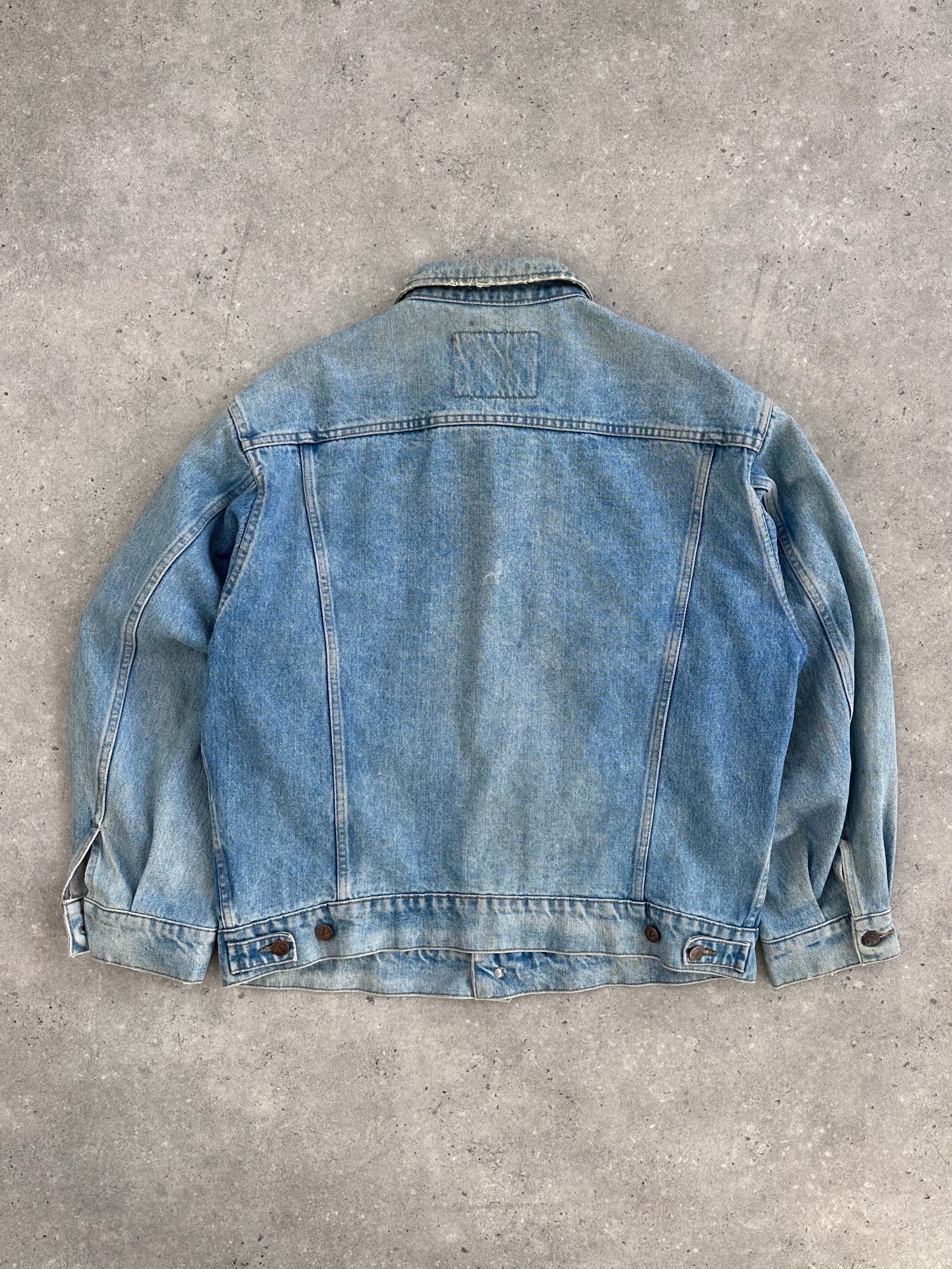 Valentino XL denim jacket displayed on a hanger, showcasing classic blue denim with signature Valentino stitching details.