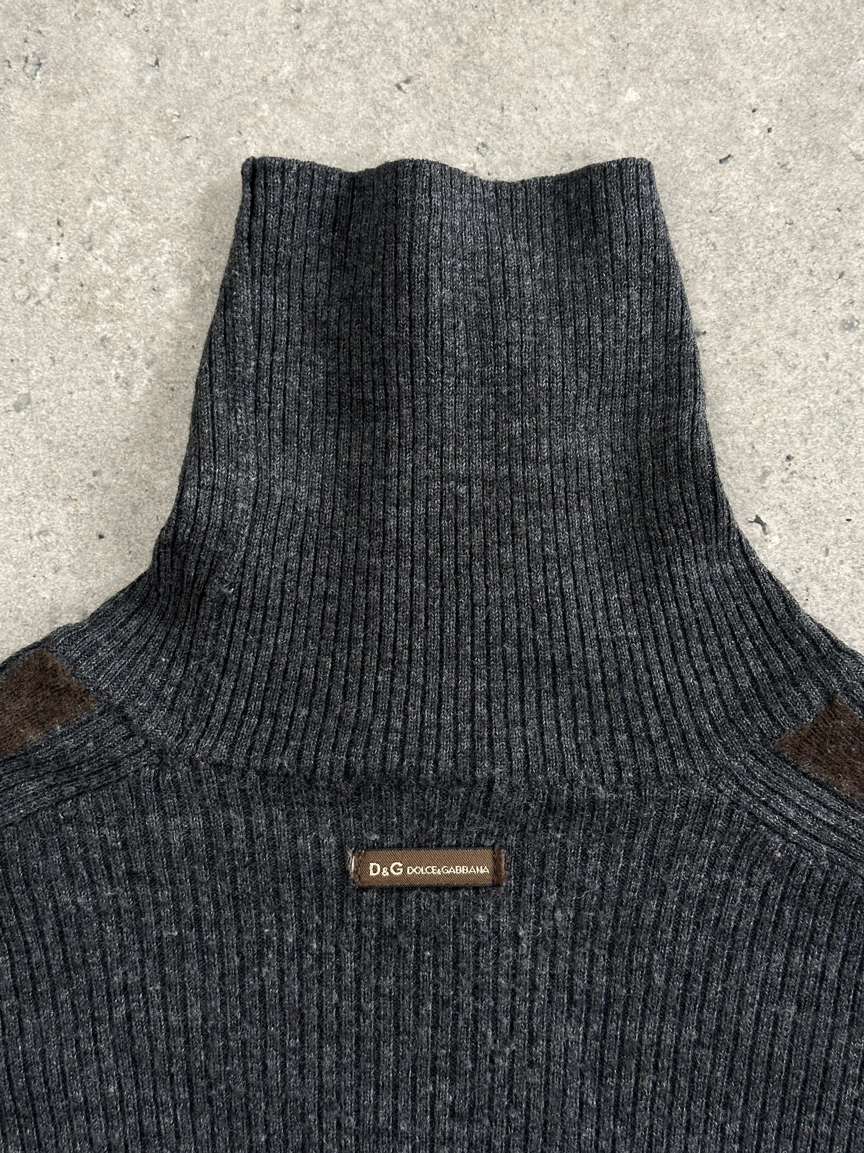 Dolce & Gabbana wool rib knit turtle neck jumper in medium, featuring a close-up of the textured fabric and classic design.