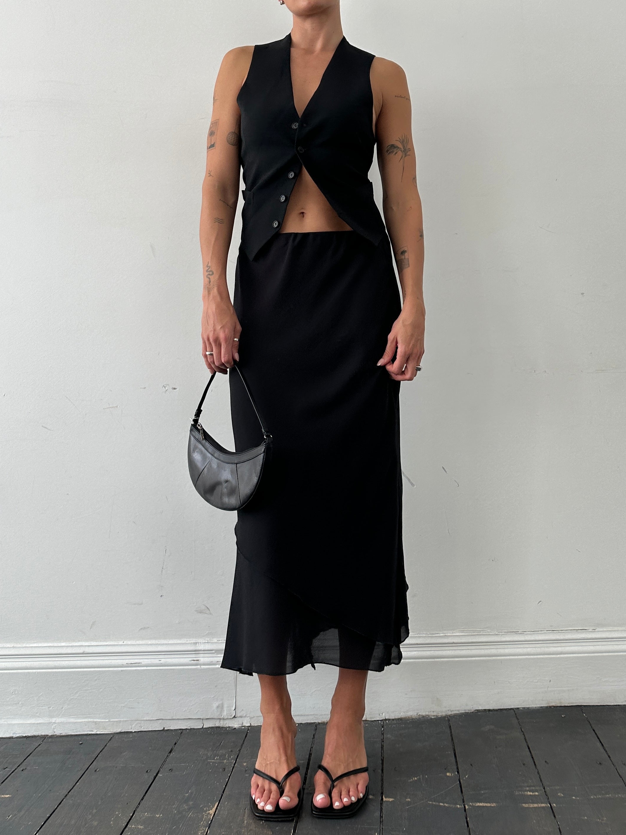 Vintage floaty double-layered midi skirt in soft fabric, styled with a high waist and flowing, layered design.
