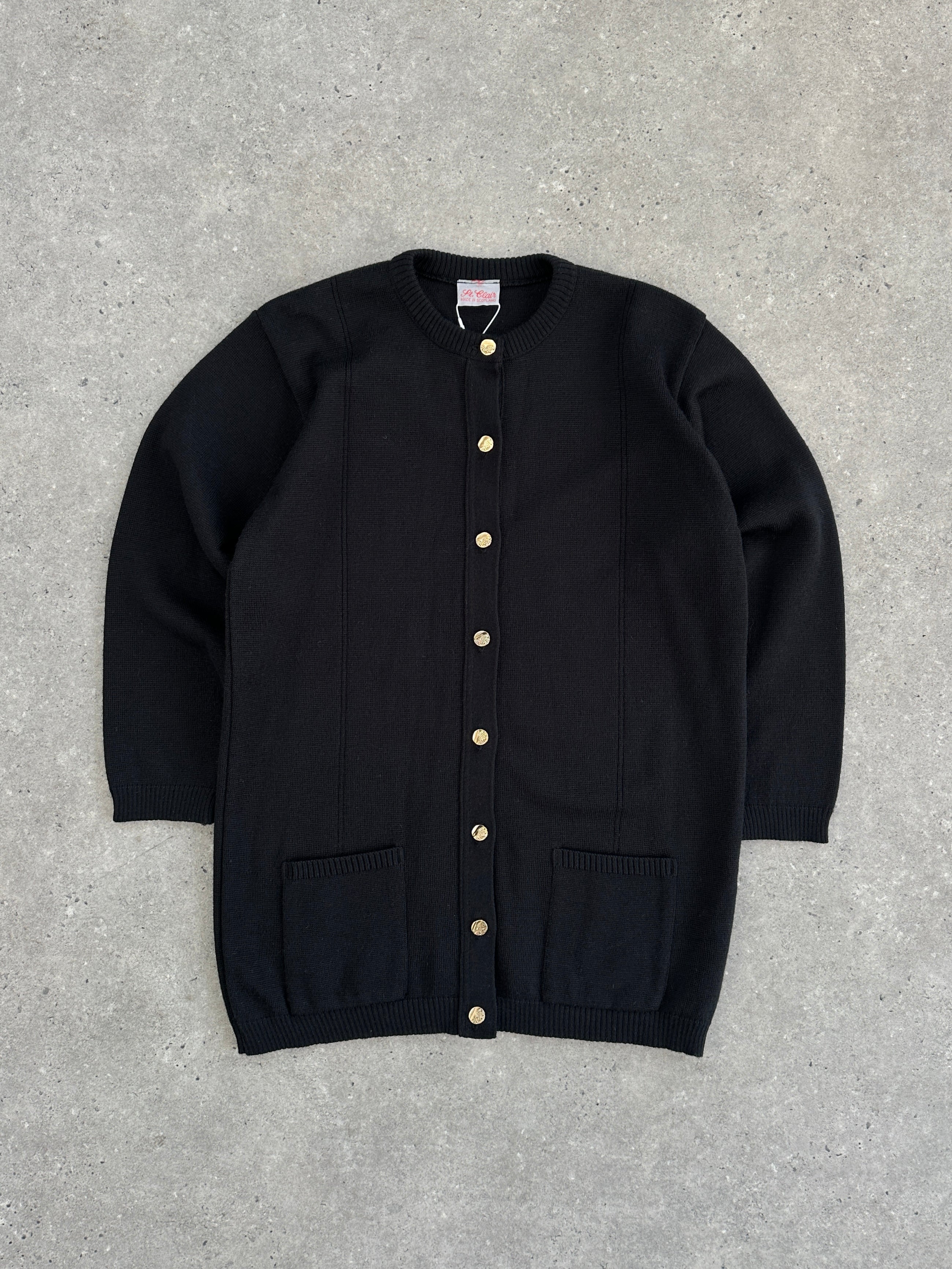 Vintage Scottish wool knitted cardigan in size M, featuring classic cable knit pattern and cozy textured fabric.