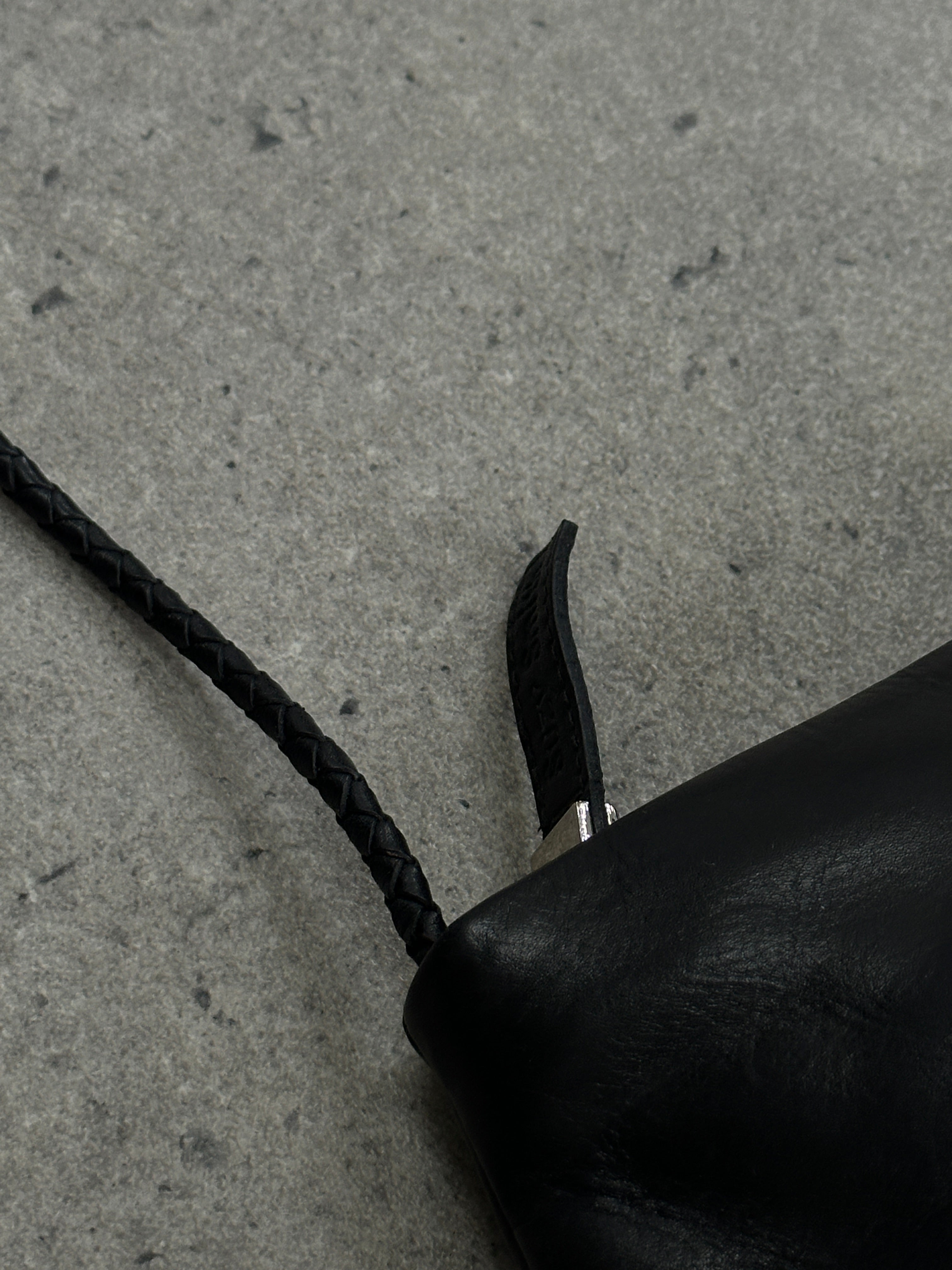 Vintage leather shoulder bag with adjustable strap and classic design, showcasing rich texture and craftsmanship.