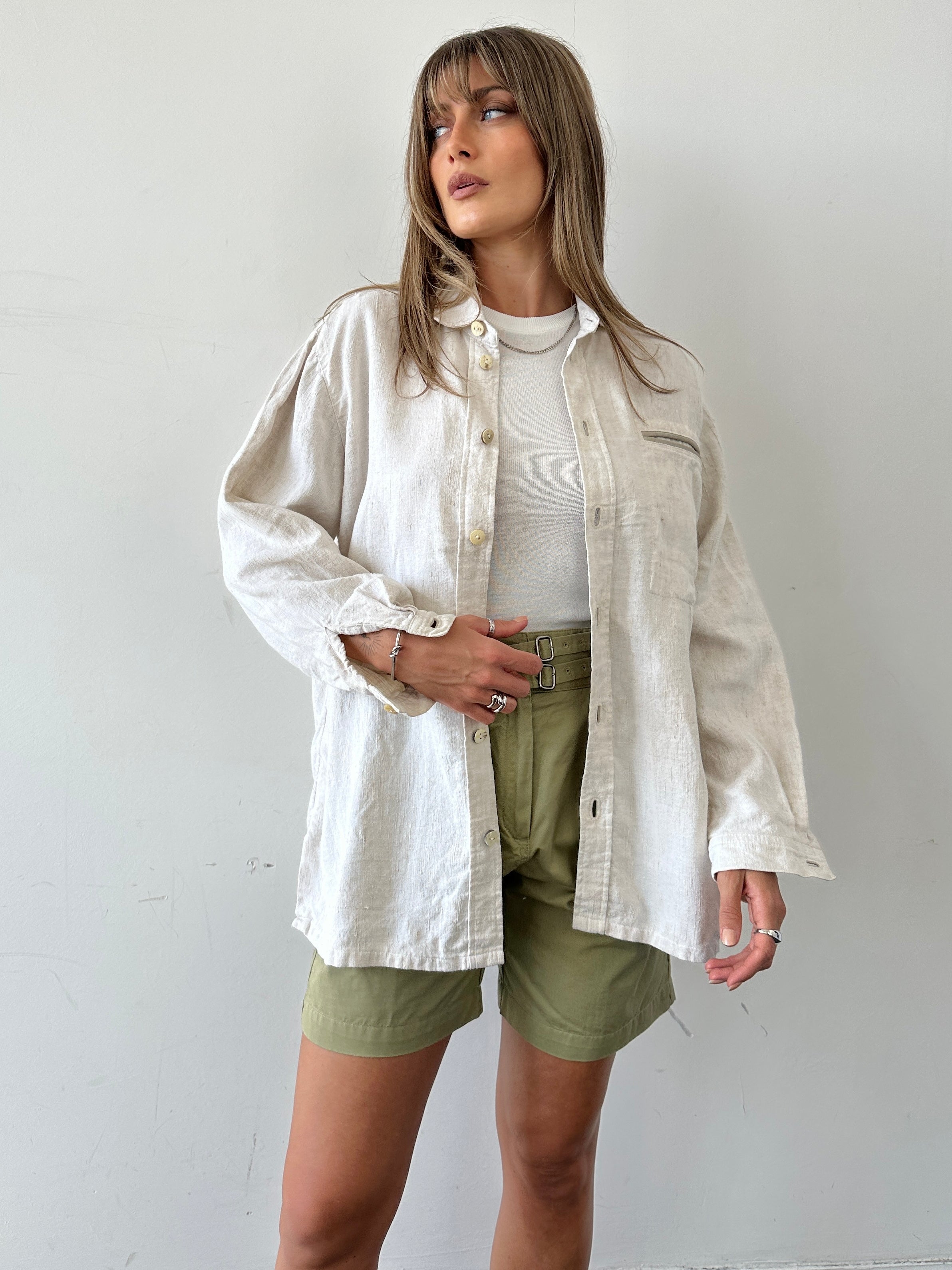 Vintage oversized linen shacket in neutral tones, showcasing relaxed fit and classic shirt design with vintage-inspired details.