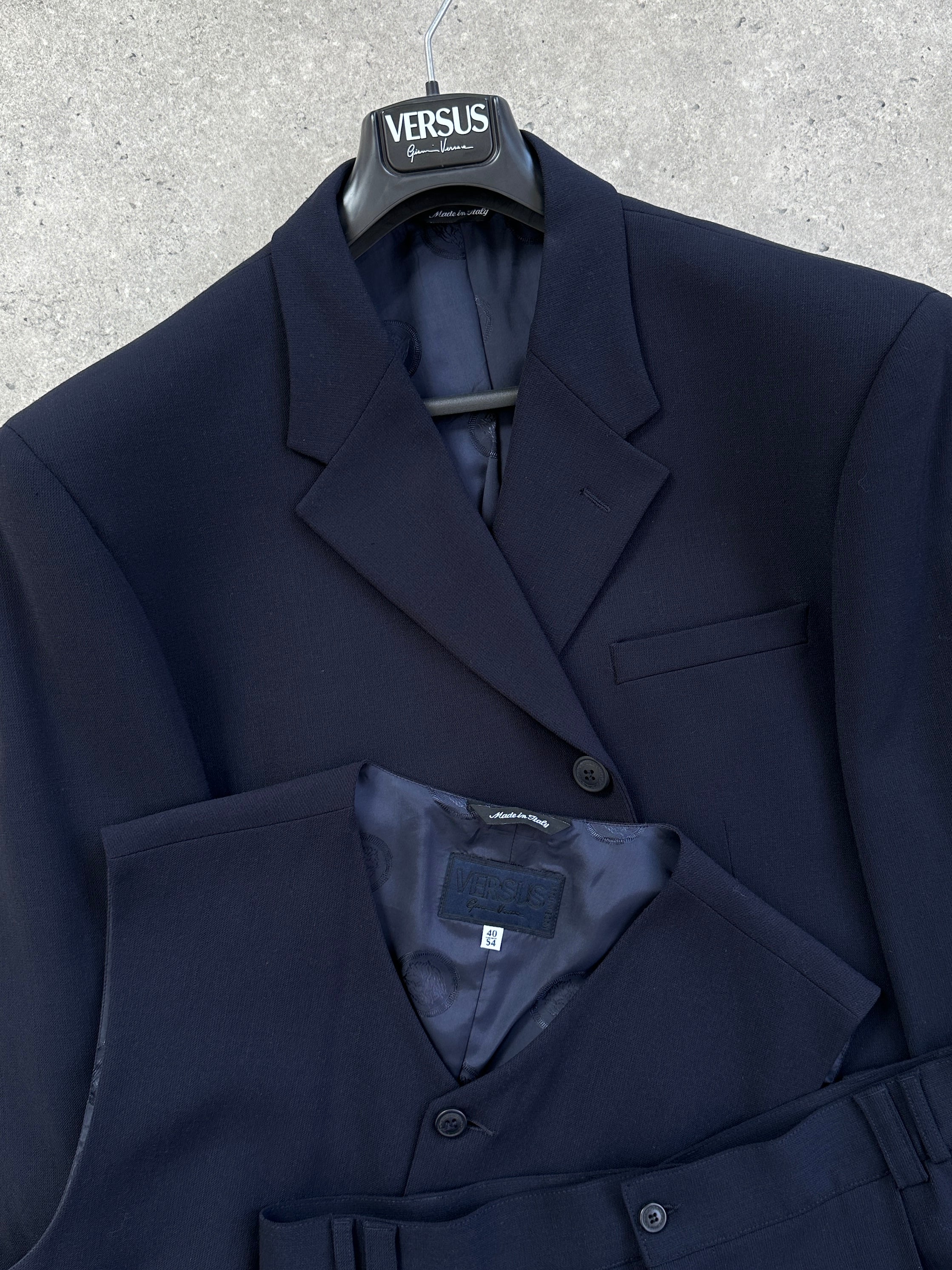 Versace Versus 1990s three-piece suit in size 48R/W32, featuring a tailored blazer, vest, and matching trousers.