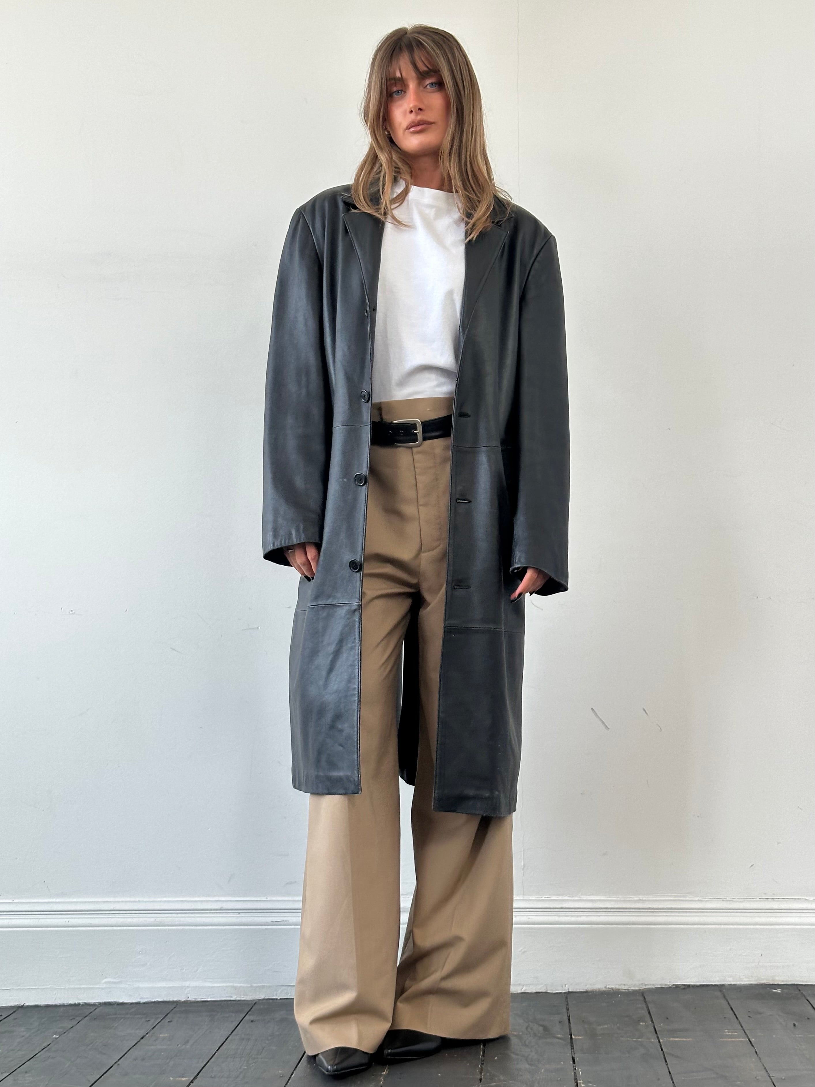 Vintage leather trench coat in XL size, stylish and classic leather jacket with a timeless design and smooth leather texture.