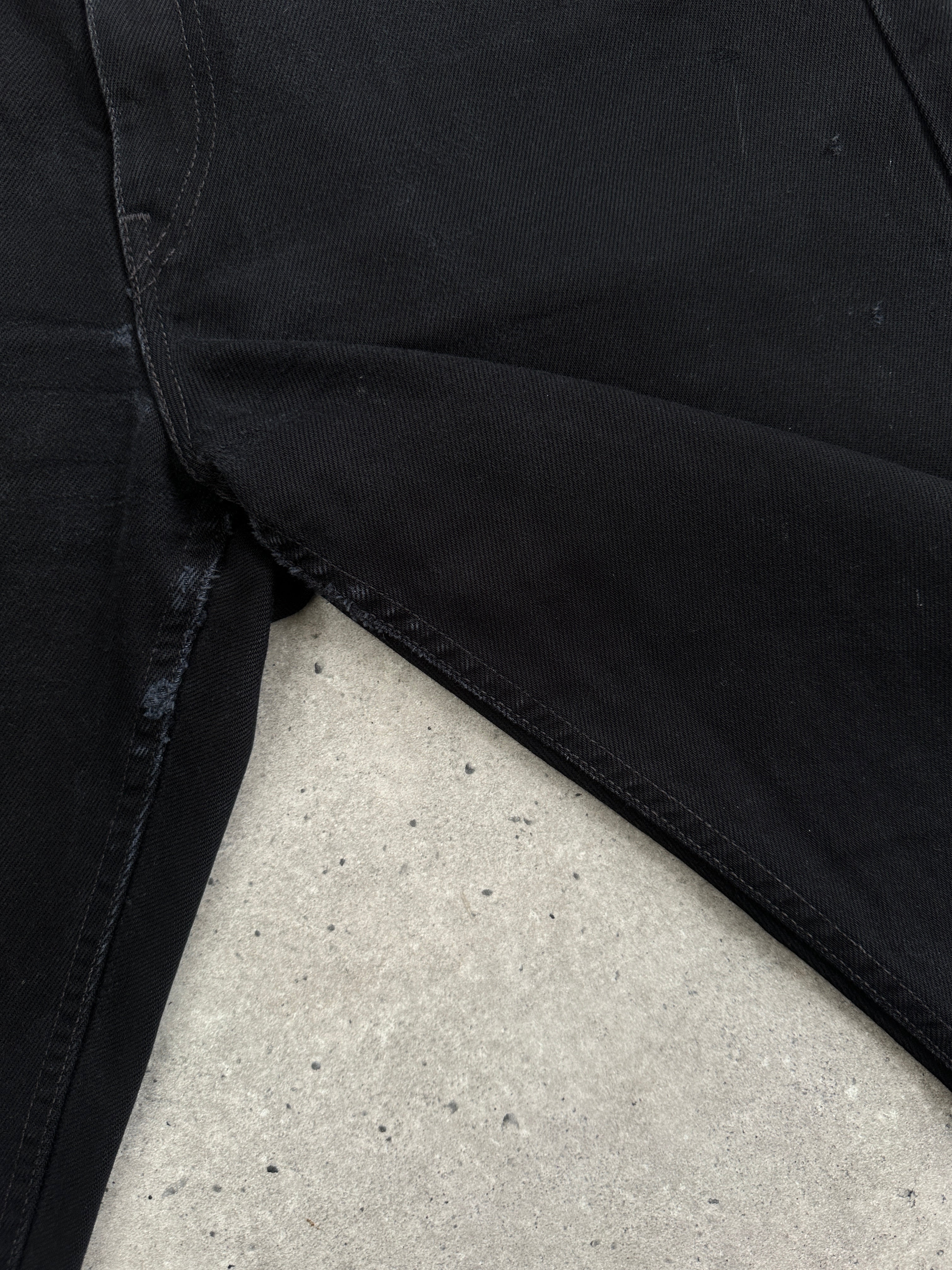 Levi’s 521 tapered straight leg denim jeans in W31, showing classic blue denim fabric and fit on a hanger.