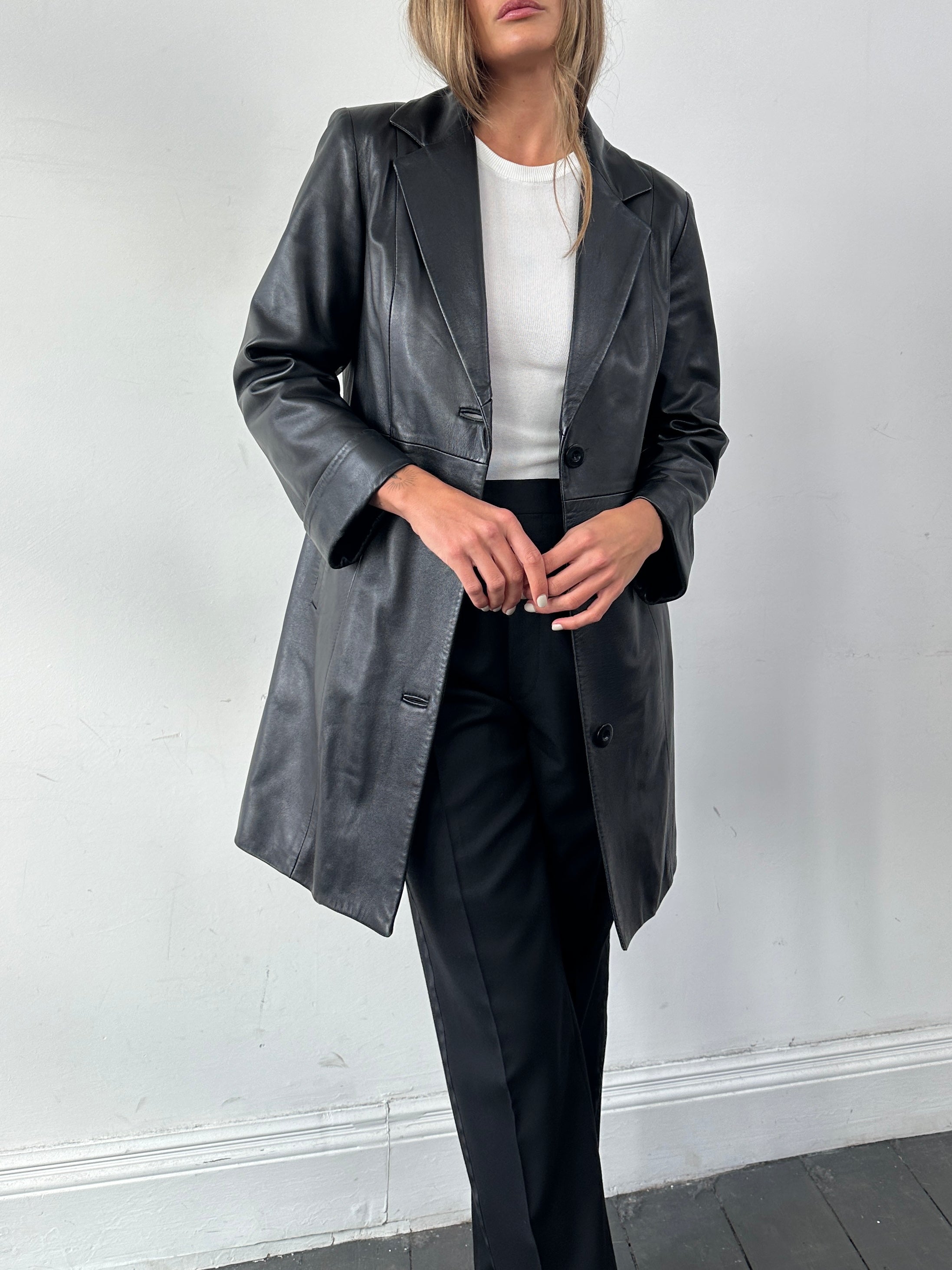 Vintage Italian vintage mid-length leather jacket for women, showing classic design and rich brown leather details.