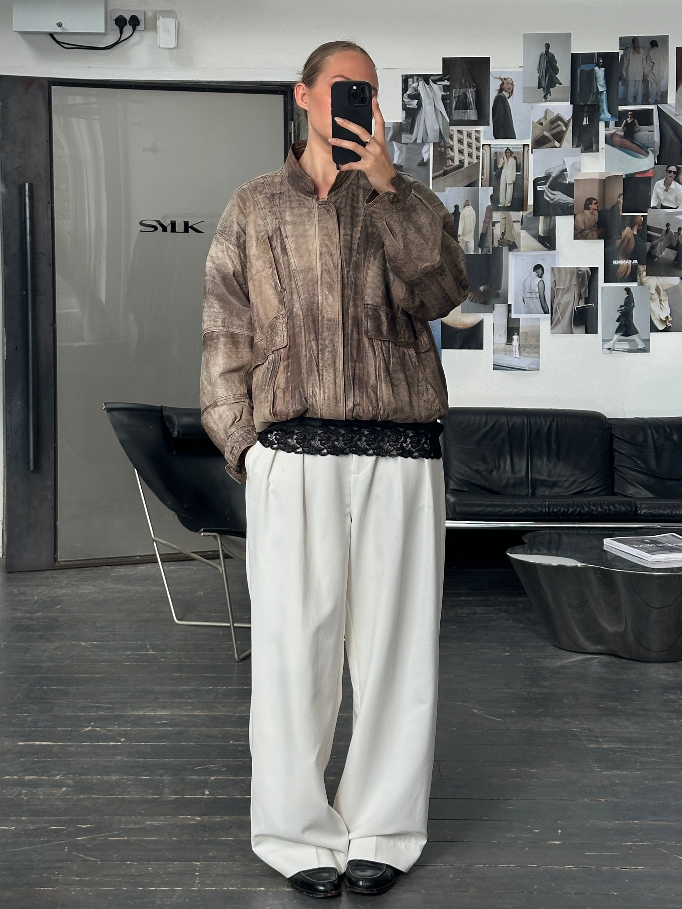 Vintage 1990s leather bomber jacket in XL, featuring classic design with a smooth leather finish and ribbed collar and cuffs.