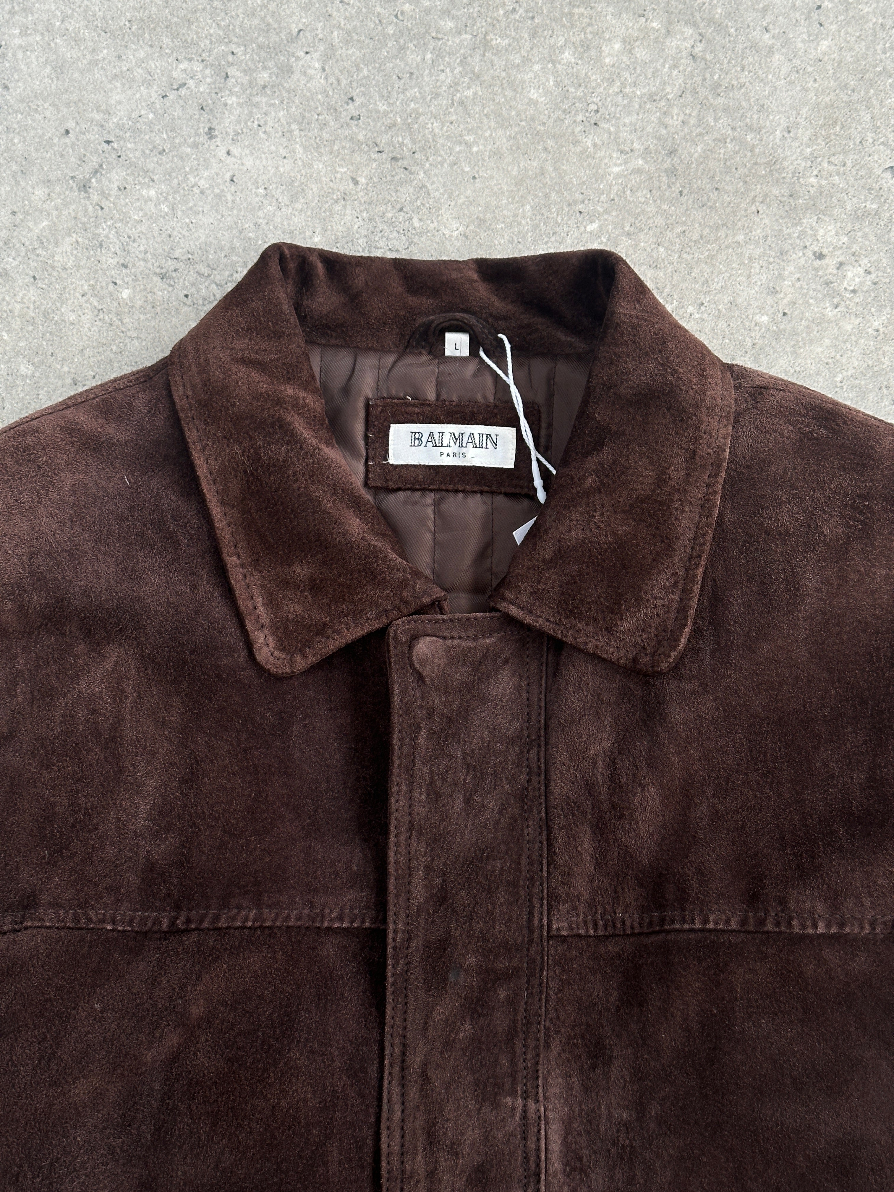 Balmain mid-length suede jacket in XL, stylish and soft with a sleek design, shown on a hanger against a neutral background.