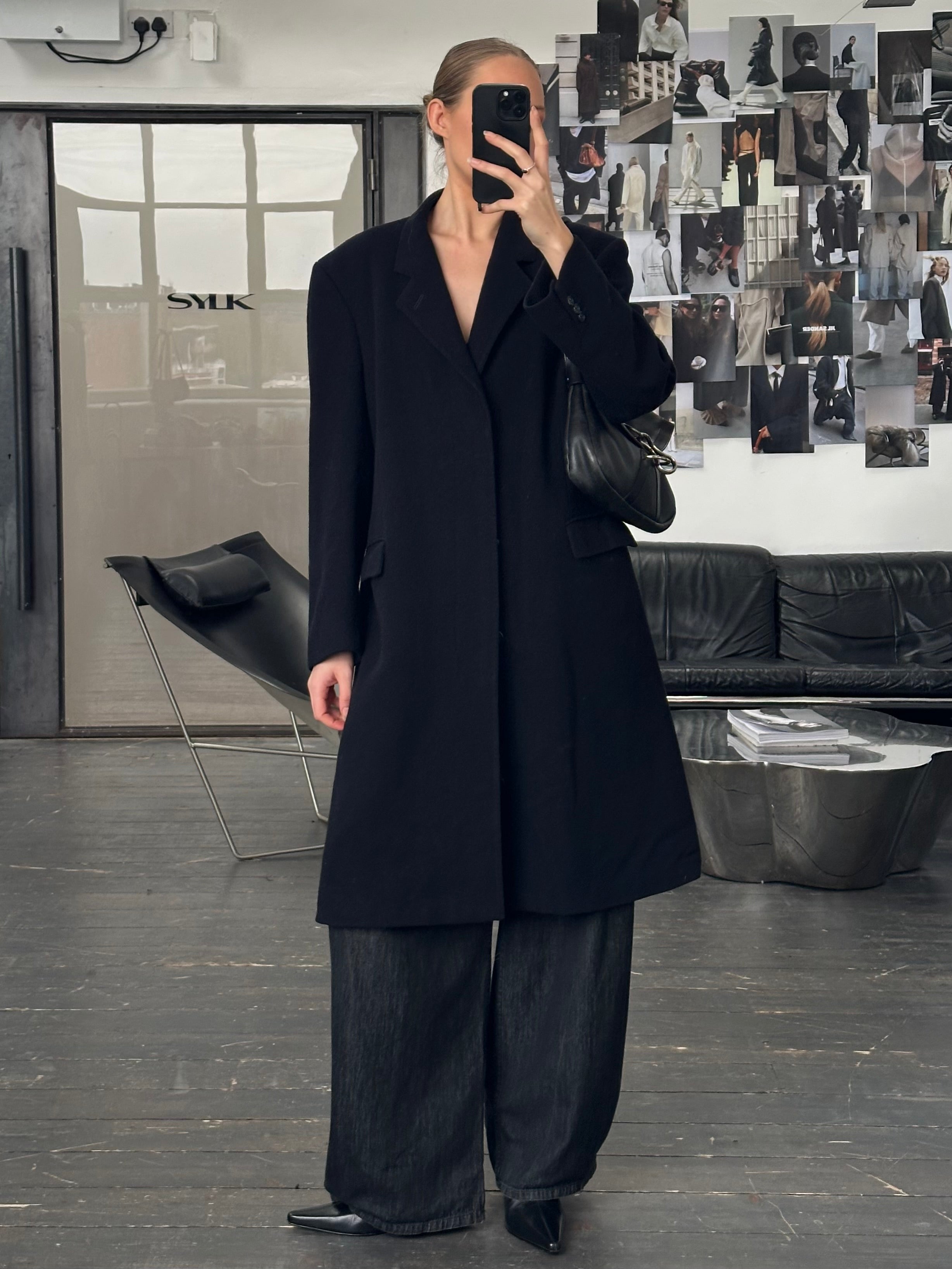 Vintage 1990s pure wool single-breasted coat in size L, featuring classic design and neutral color, displayed on a hanger.