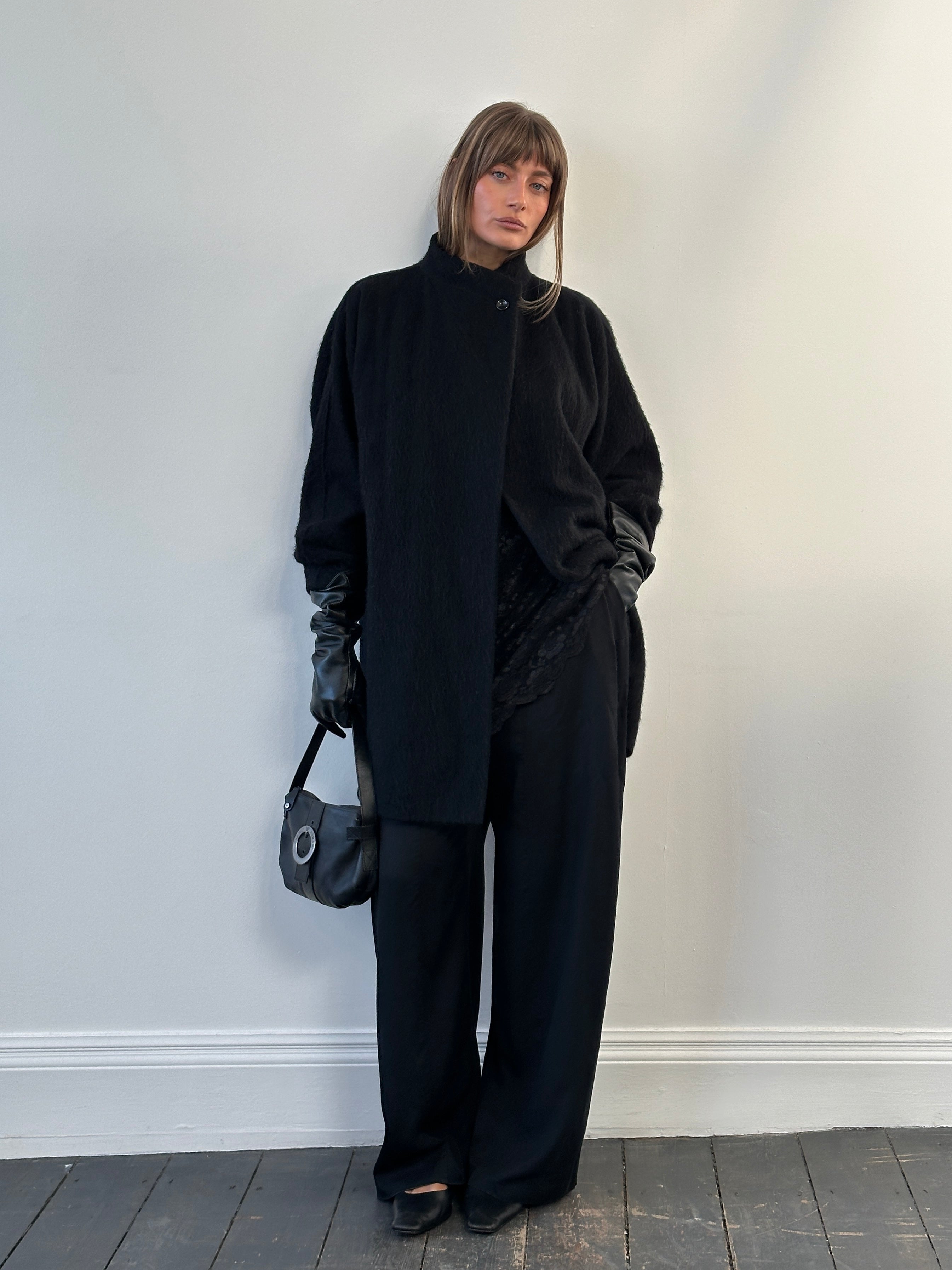 Vintage 1990s wool mohair high-neck coat, medium size, with a classic high collar and textured fabric, displayed on a hanger.